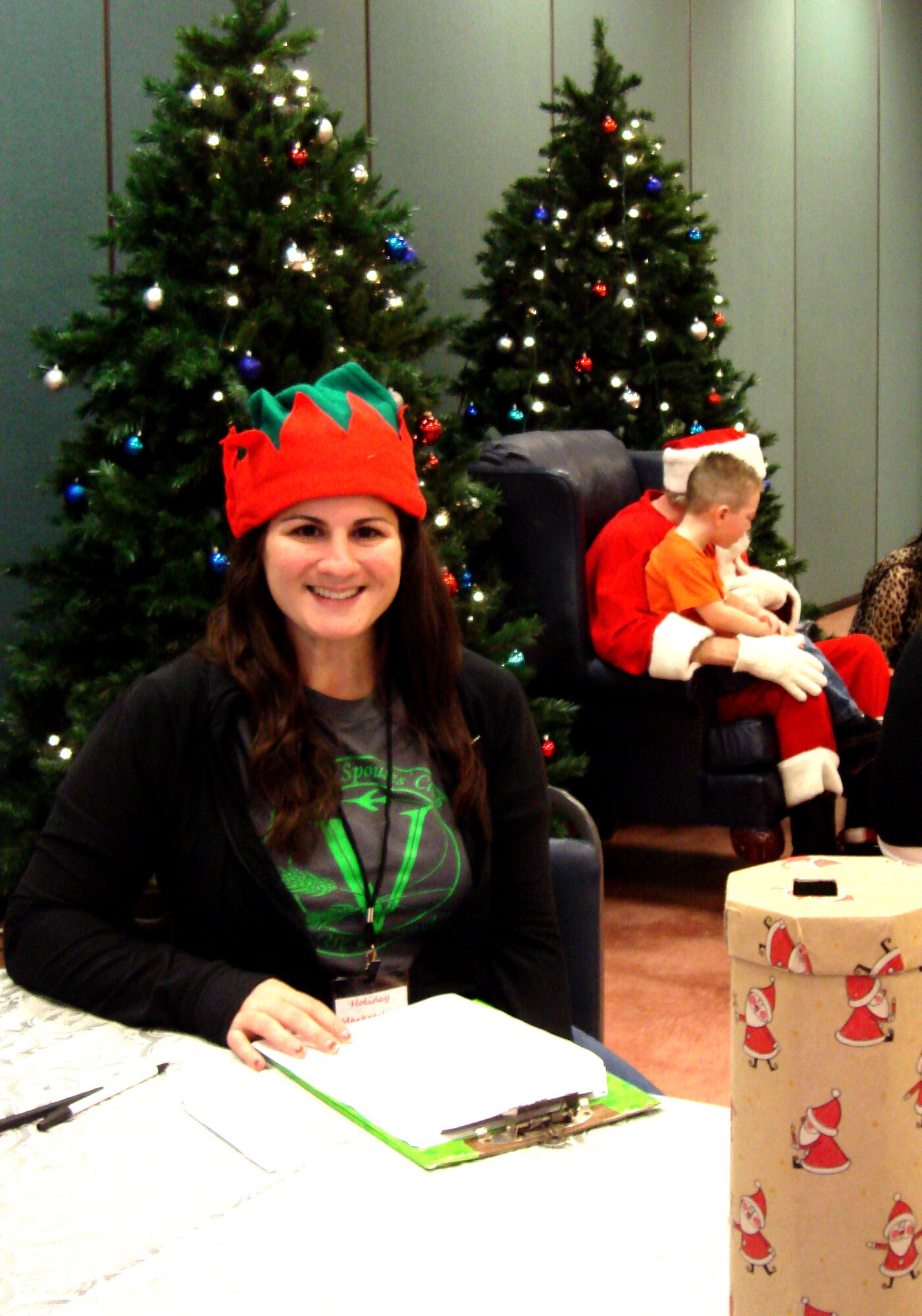 Elizabeth Seis, the Vance Officers’ Spouses’ Club historian and volunteer, works the front door at the OSC annual Holiday Marketplace, Nov. 9, at the Chisholm Trail Expo Center in Enid. (U.S. Air Force photo/ Sarina Houston)