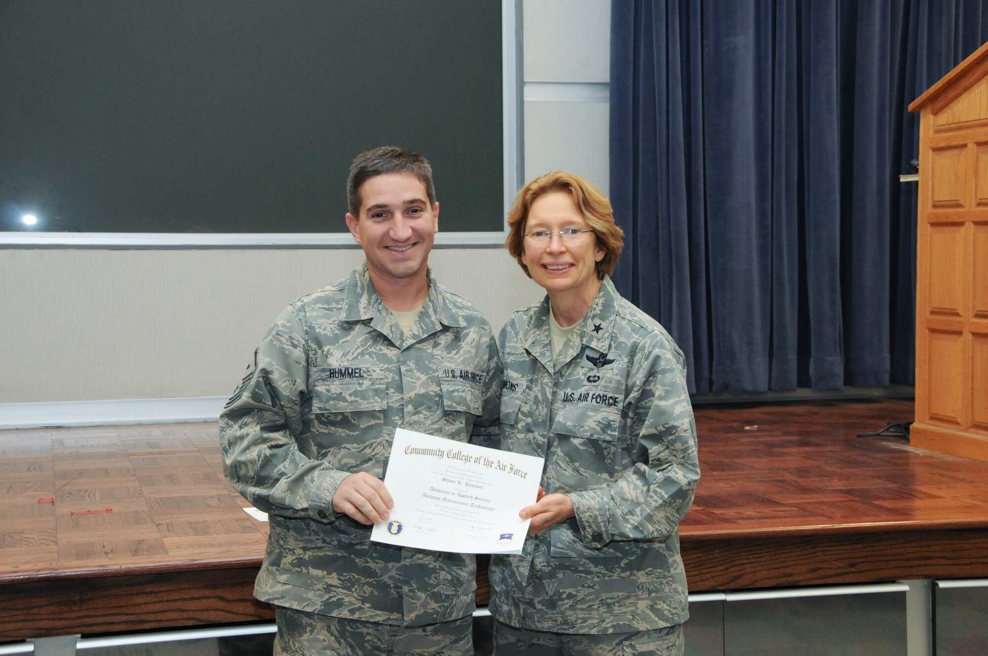 U.S. Air Force Master Sgt. Shane Hummel, left, a member of the 166th Civil Engineer Squadron, 166th Airlift Wing, receives a certificate from Brig. Gen. Carol Timmons, assistant adjutant general for air, Delaware National Guard to recognize Hummel’s attainment of a Community College of the Air Force associate of applied science degree in aircraft maintenance technology at a CCAF Class of October 2013 graduation ceremony held Nov. 3, 2013 at the New Castle Air National Guard Base, Del. (U.S. Air National Guard photo by Tech. Sgt. Robin Meredith)