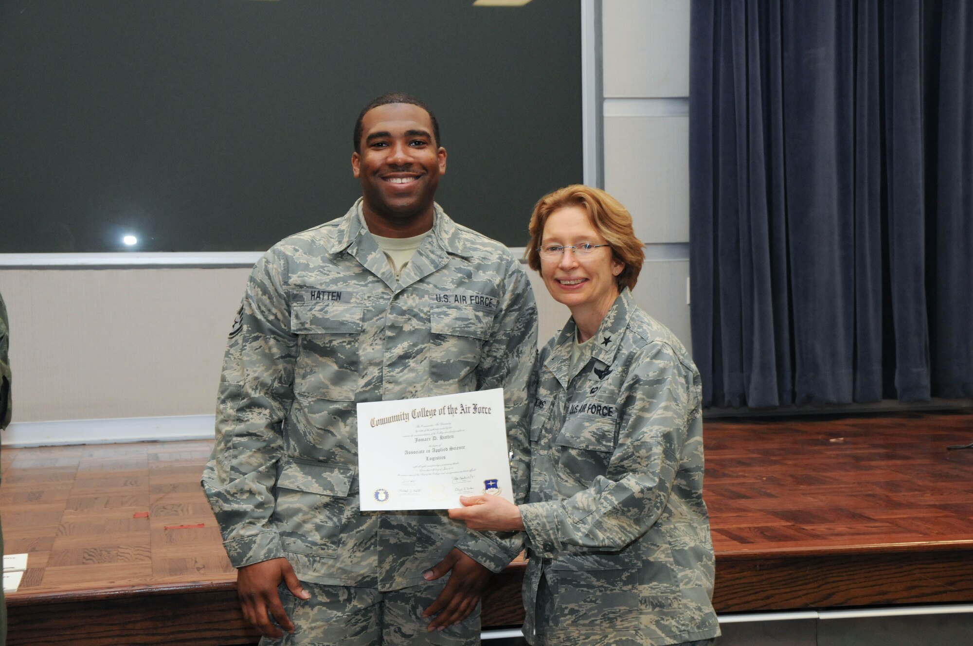 U.S. Air Force Staff Sgt. Jomarr Hatten, left, a member of the 166th Logistics Readiness Squadron, 166th Airlift Wing, receives a certificate from Brig. Gen. Carol Timmons, assistant adjutant general for air, Delaware National Guard to recognize Hatten’s attainment of a Community College of the Air Force associate of applied science degree in logistics a CCAF Class of October 2013 graduation ceremony held Nov. 3, 2013 at the New Castle Air National Guard Base, Del. (U.S. Air National Guard photo by Tech. Sgt. Robin Meredith)