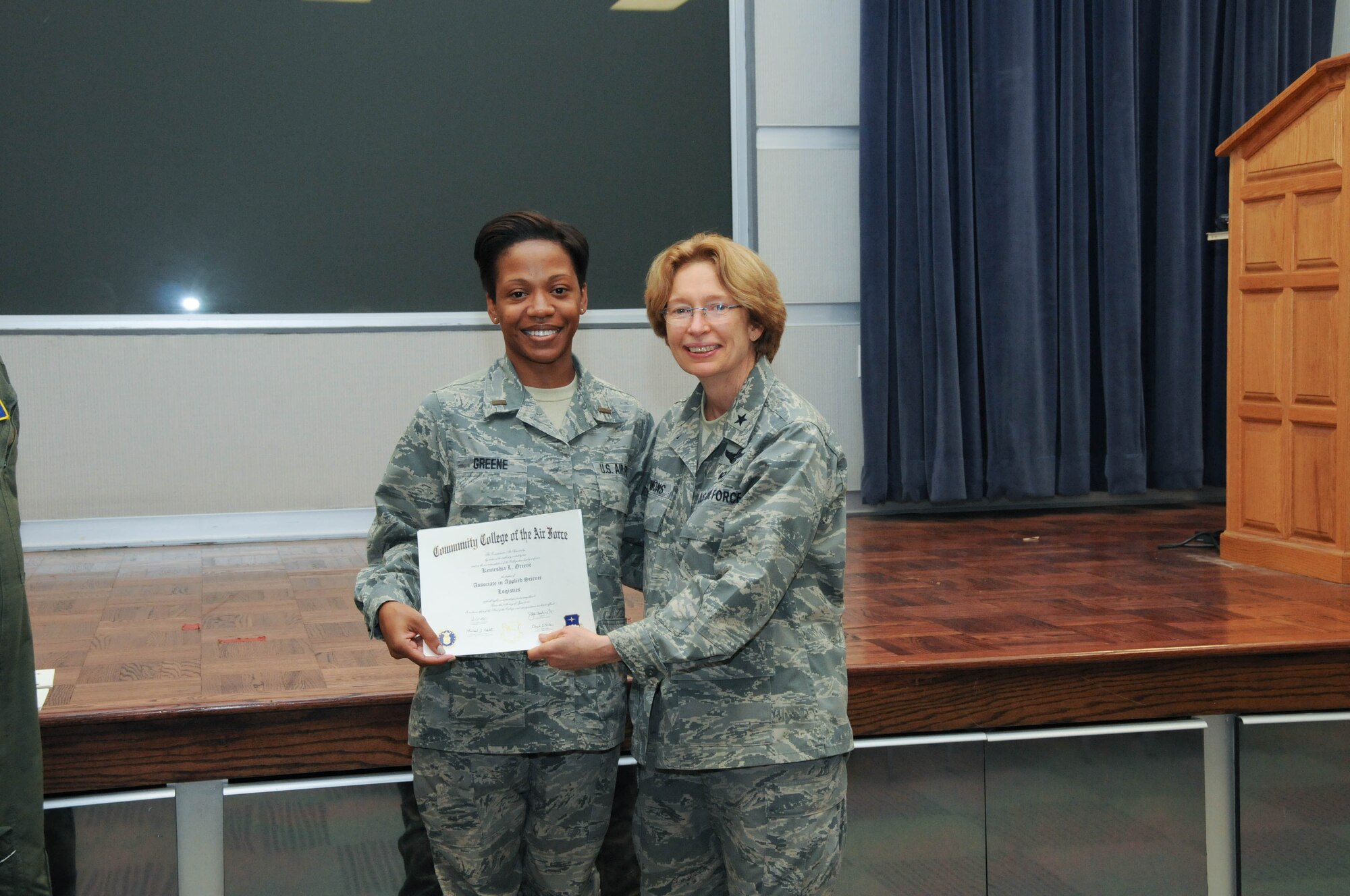 U.S. Air Force Master Sgt. (now 1st Lt.) Kemeshia Greene, left, a member of the 142nd Airlift Squadron, 166th Airlift Wing, receives a certificate from Brig. Gen. Carol Timmons, assistant adjutant general for air, Delaware National Guard to recognize Greene’s attainment of a Community College of the Air Force associate of applied science degree in logistics a CCAF Class of October 2013 graduation ceremony held Nov. 3, 2013 at the New Castle Air National Guard Base, Del. (U.S. Air National Guard photo by Tech. Sgt. Robin Meredith)