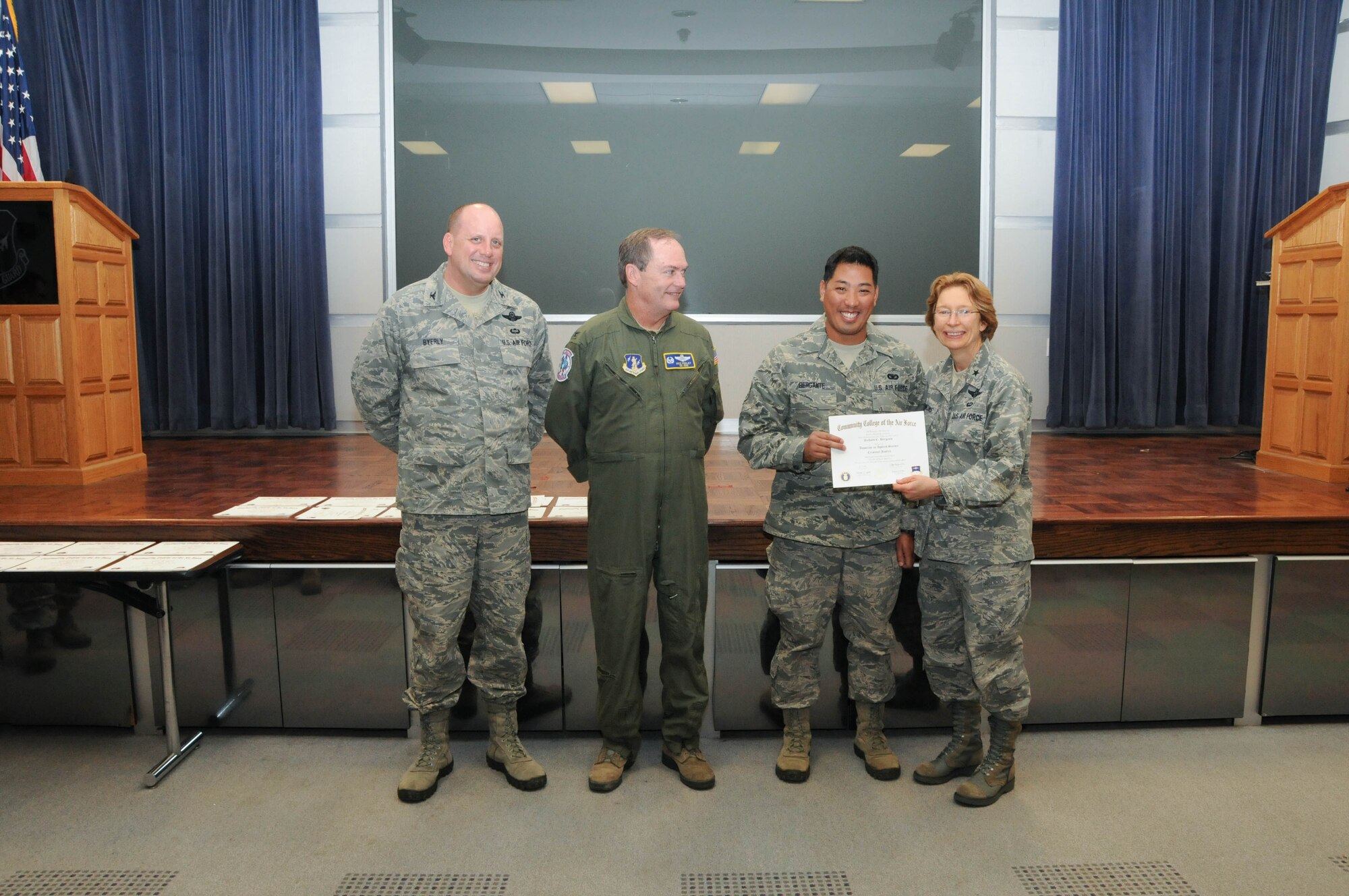U.S. Air Force Staff Sgt. Richard Bergante, second from right, a member of the 166th Security Forces Squadron, 166th Airlift Wing, receives a certificate from Brig. Gen. Carol Timmons, assistant adjutant general for air, Delaware National Guard to recognize Bergante’s attainment of a Community College of the Air Force associate of applied science degree in criminal justice at a CCAF Class of October 2013 graduation ceremony held Nov. 3, 2013 at the New Castle Air National Guard Base, Del. 166th AW Commander Col. Mike Feeley, second from left, is next to 166th AW Vice-Commander Col. Dave Byerly, left. (U.S. Air National Guard photo by Tech. Sgt. Robin Meredith)