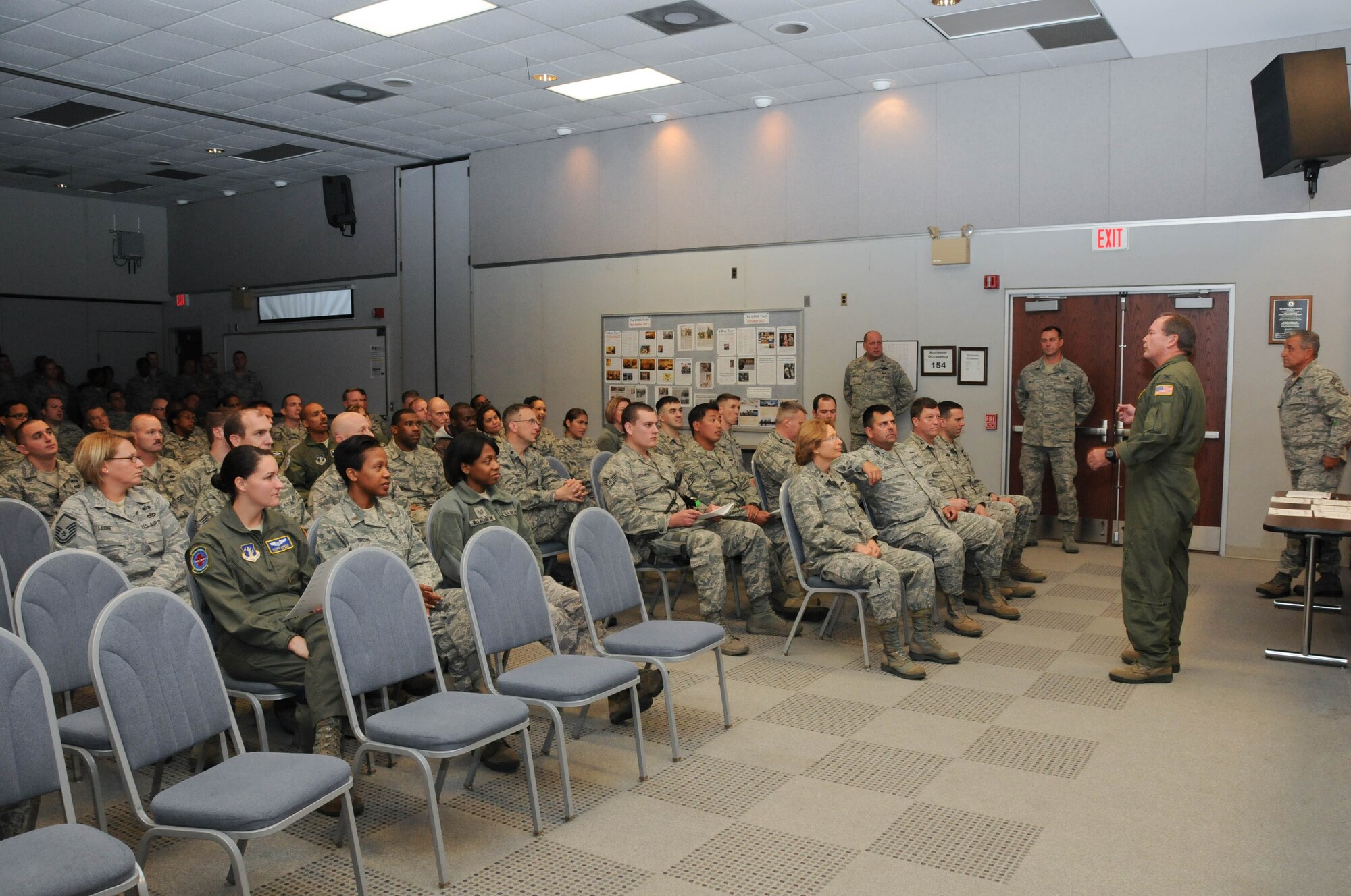 U.S. Air Force Col. Mike Feeley, commander, 166th Airlift Wing, addresses Delaware Air National Guard Airmen at a Community College of the Air Force Class of October 2013 graduation ceremony held Nov. 3, 2013 at the New Castle ANG Base, Del. A total of 21 unit Airmen earned 23 associate of applied science degrees in 14 degree programs. (U.S. Air National Guard photo by Tech. Sgt. Robin Meredith)