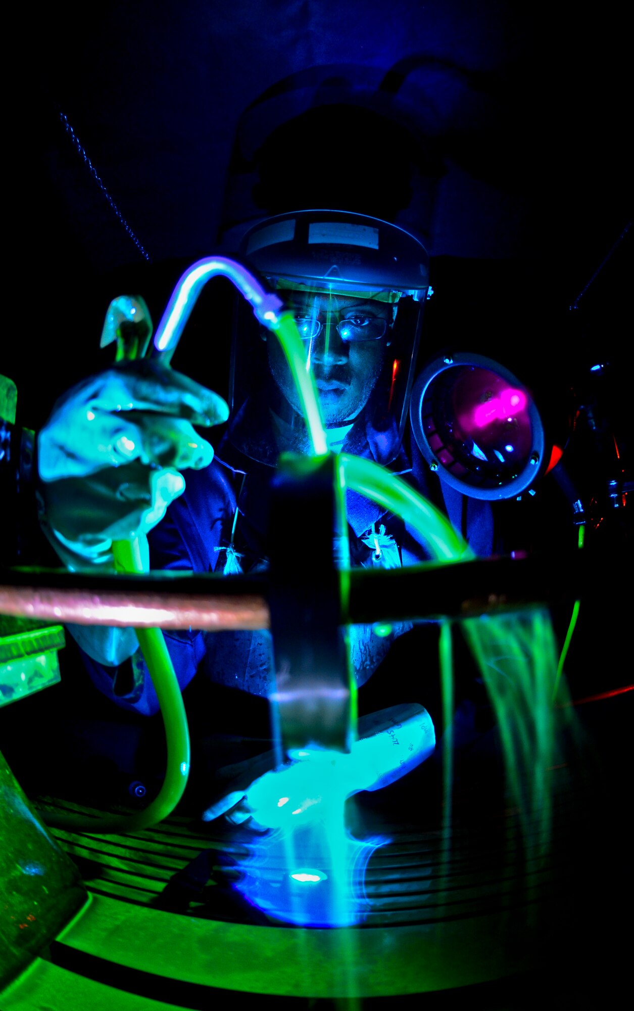 Staff Sgt. Dustin Harris, 6th Maintenance Squadron nondestructive inspection technician, washes a Ketos ring with a magnetic particle solution at MacDill Air Force Base, Fla., Nov. 7, 2013. The Ketos ring is inspected weekly to ensure the machine is working properly. (U.S. Air Force photo by Staff Sgt. Brandon Shapiro/Released)