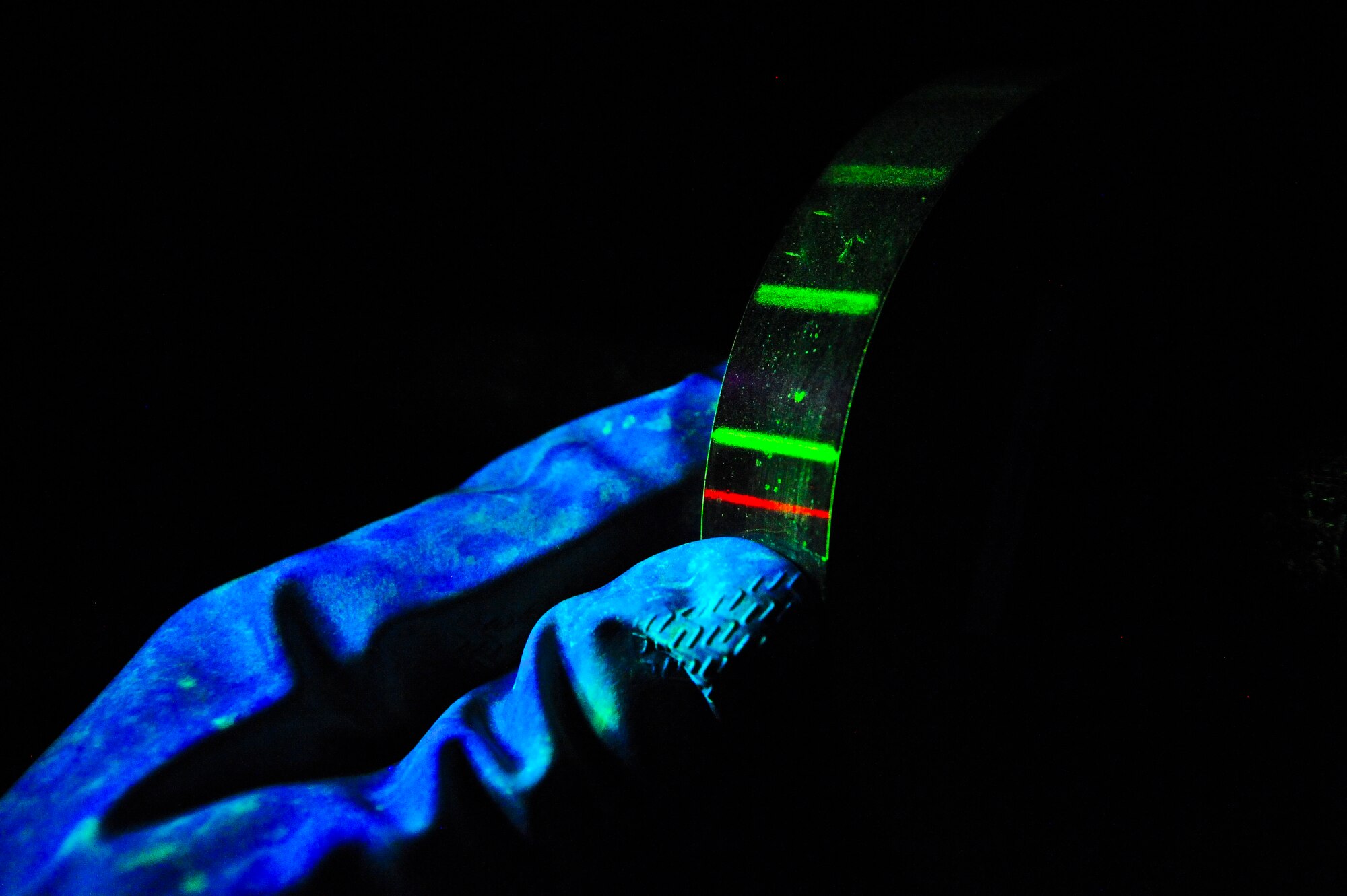 A Ketos ring is inspected after a magnetic particle solution bath at MacDill Air Force Base, Fla., Nov. 7, 2013. Nondestructive inspection Airmen are trained to notice the different types of defects in aircraft parts. (U.S. Air Force photo by Airman 1st Class Ned T. Johnston/Released)