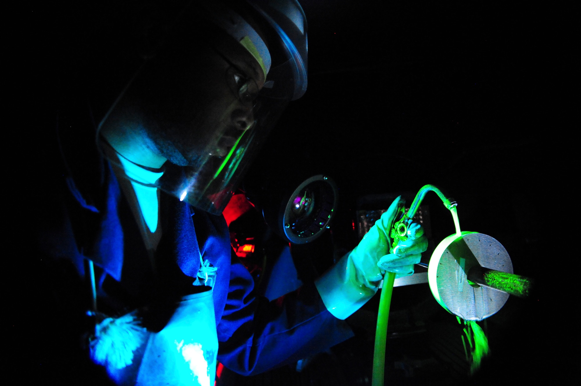 Staff Sgt. Dustin Harris, 6th Maintenance Squadron nondestructive inspection technician, washes a Ketos ring with a magnetic particle solution at MacDill Air Force Base, Fla., Nov. 7, 2013. The wet horizontal magnetic particle inspection unit is one of seven different types of inspections that NDI Airmen use to inspect aircraft parts. (U.S. Air Force photo by Airman 1st Class Ned T. Johnston/Released)