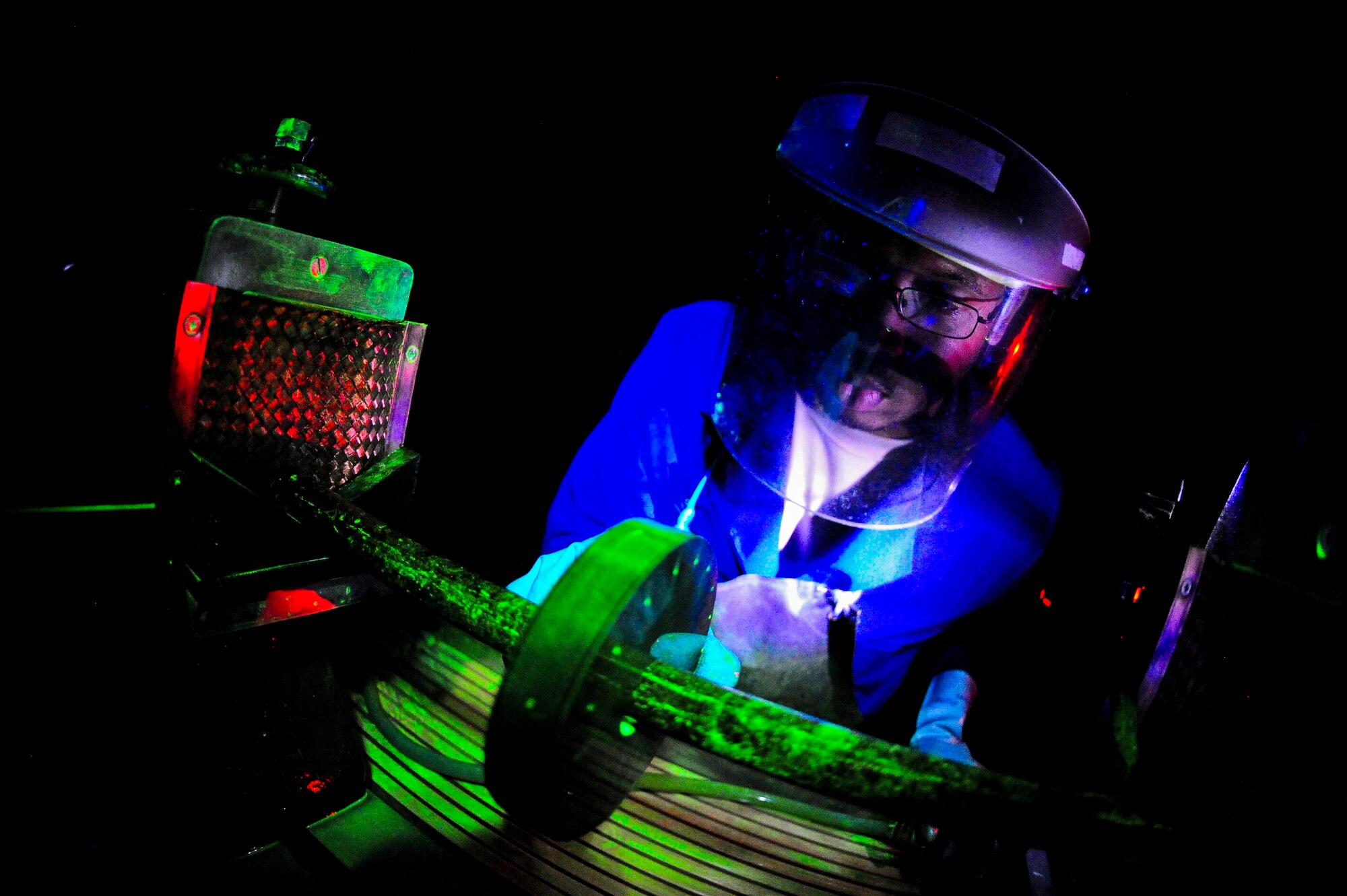 Staff Sgt. Dustin Harris, 6th Maintenance Squadron nondestructive inspection technician, inspects a Ketos ring for defects at MacDill Air Force Base, Fla., Nov. 7, 2013. NDI Airmen are trained to notice the smallest of cracks in aircraft parts. (U.S. Air Force photo by Airman 1st Class Ned T. Johnston/Released)