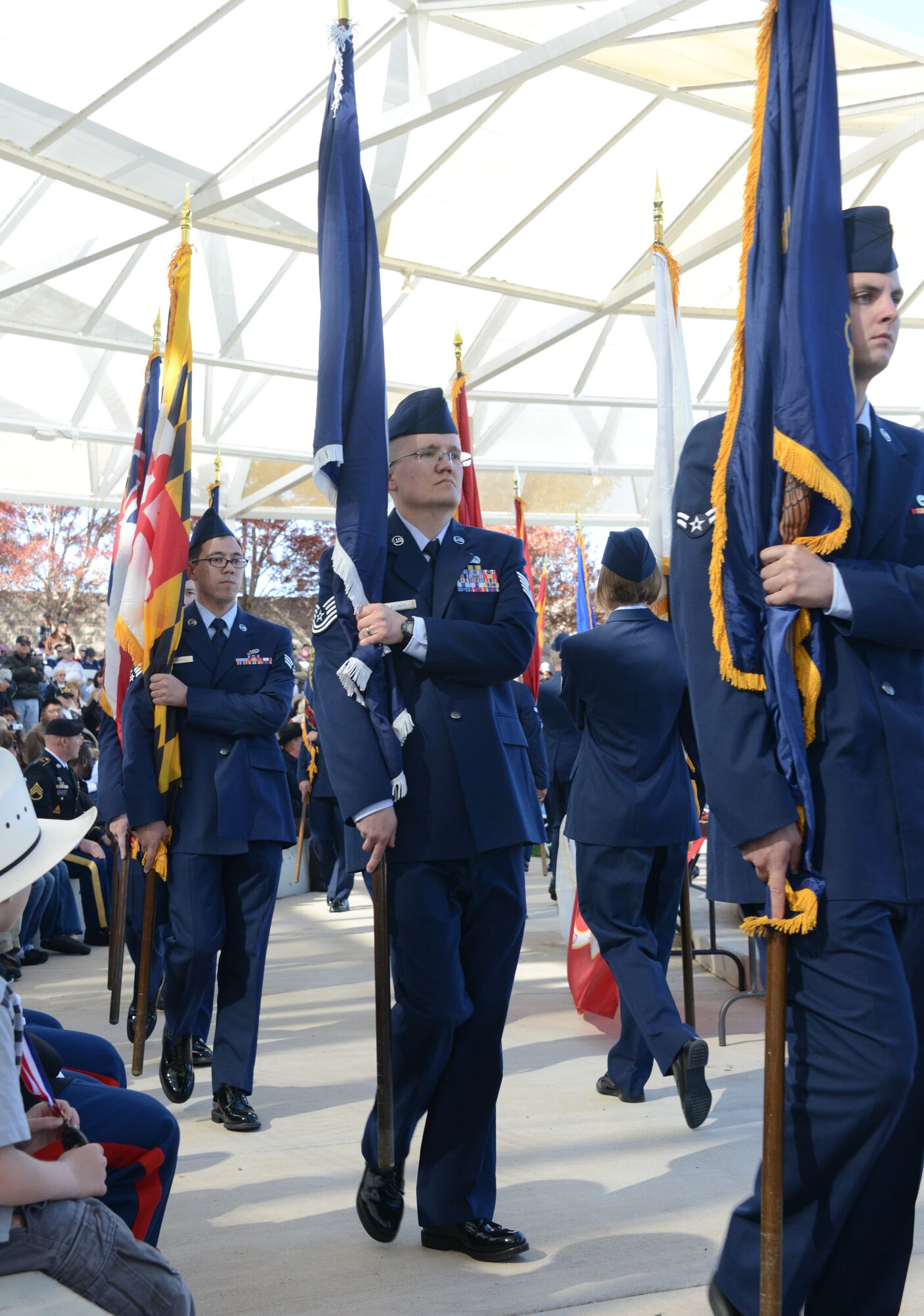 Tech. Sgt. Jason Beeney, center, from the Air Force Inspection Agency, is one of 50 Airmen from various units across the base to walk in the parade of flags at the Veterans Day Ceremony at Memorial Park Nov. 11.  (Photo by Dennis Carlson)