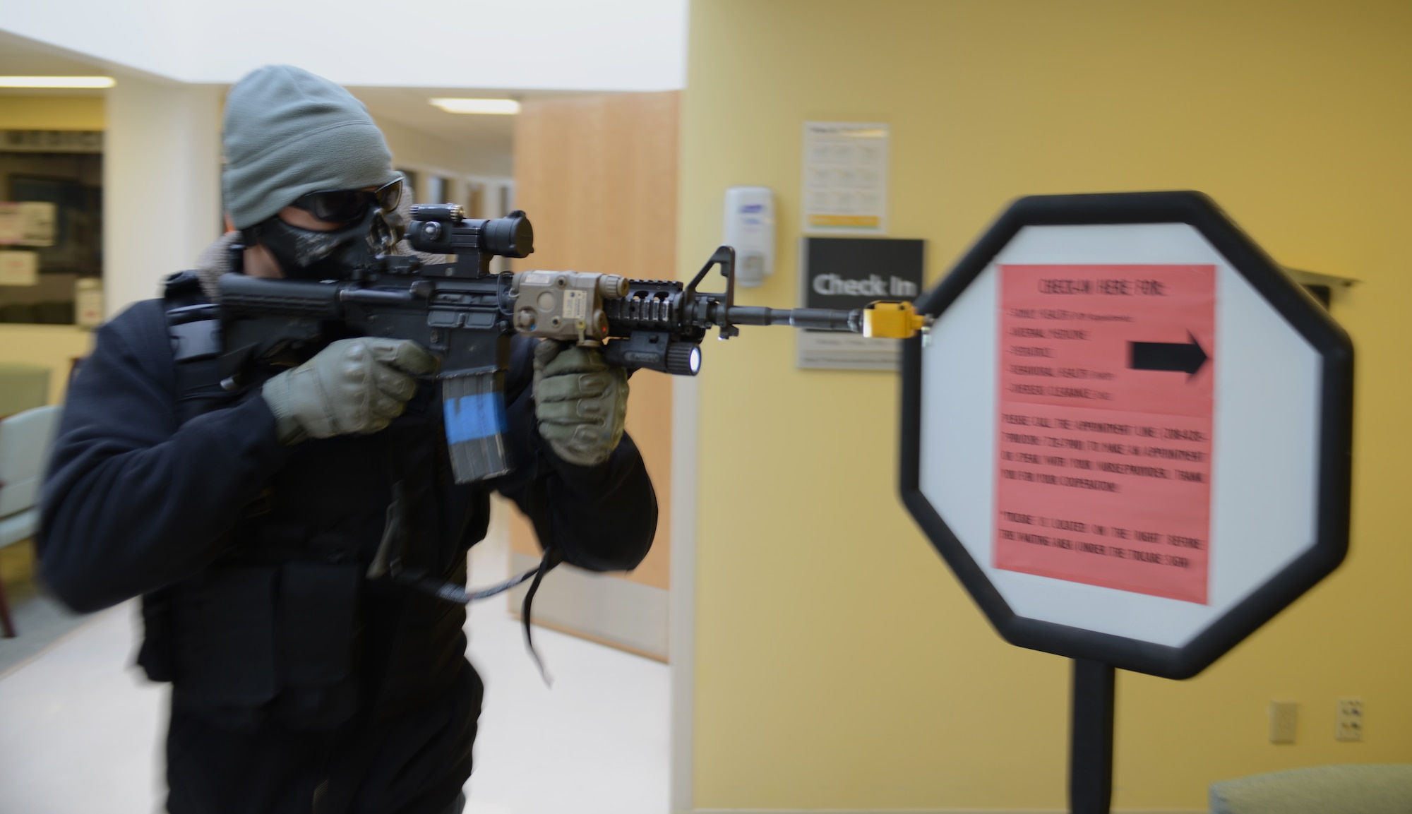 Staff Sgt. Mike Hejmanowski, 366th Security Forces Squadron evaluator,  moves quickly through the base hospital Nov. 6, 2013, during an active-shooter training exercise at Mountain Home Air Force Base, Idaho. The confusion during the exercise tested hospital personnel as well as the security systems in place to address such a situation. (U.S. Air Force photo by Senior Airman Benjamin Sutton/RELEASED)