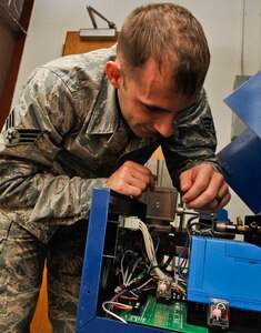 U.S. Air Force Senior Airman Christopher White, 633rd Civil Engineer Squadron heating, ventilation and air conditioning element journeyman, inspects wire connections on a boiler at Langley Air Force Base, Va., Nov. 8, 2013. The HVAC element is required to conduct inspections on all heating and air conditioning units across the base twice a year.  (U.S. Air Force photo by Staff Sgt. Wesley Farnsworth/Released)