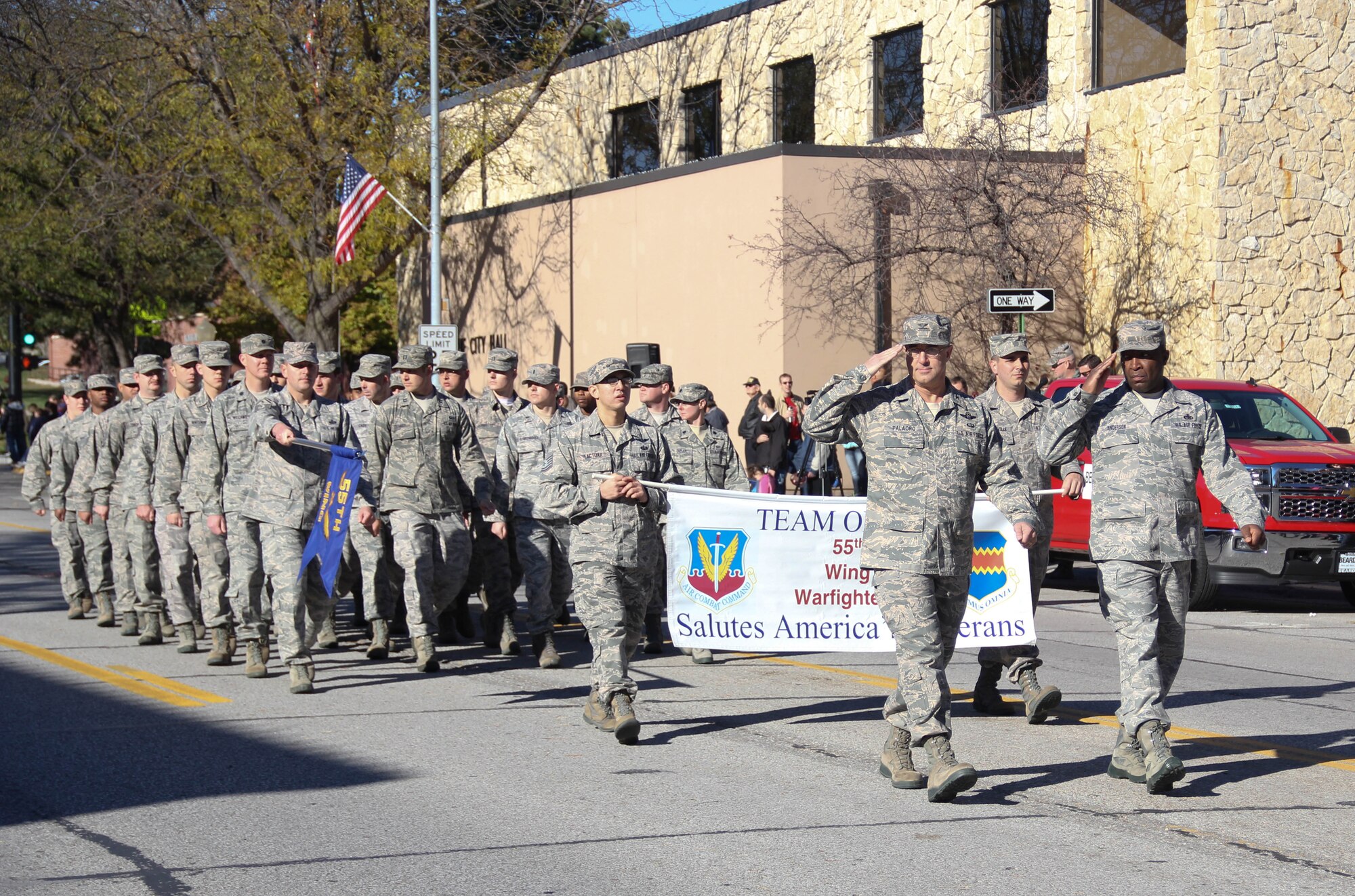 U.S. Air Force Col. Hans Palaoro, 55th Wing vice commander, leads members of the 55th Wing staff during the 14th annual Veterans Day Parade in Olde Towne Bellevue, Neb., Nov. 9. The 55th Wing, U.S. Strategic Command and Air Force Weather Agency joined with members from the community to honor veterans at this annual parade. (U.S. Air Force photo by 2nd Lt. Carly A. Costello/Released)