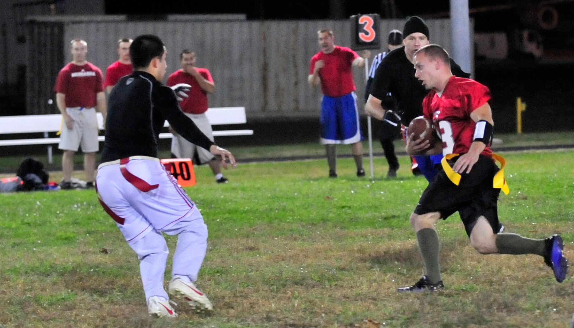 Thomas Pope, 436th Civil Engineer Squadron receiver, runs for a first down as the 436th Maintenance Group/Maintenace Operations Flight attempts to grab his flag during a flag football Nov. 6, 2013, at Dover Air Force Base, Del. The 436th CES, the defending base champions, won the game 25-6 and improved its record to 2-0 on the season. (U.S. Air Force photo/Tech. Sgt. Chuck Walker)