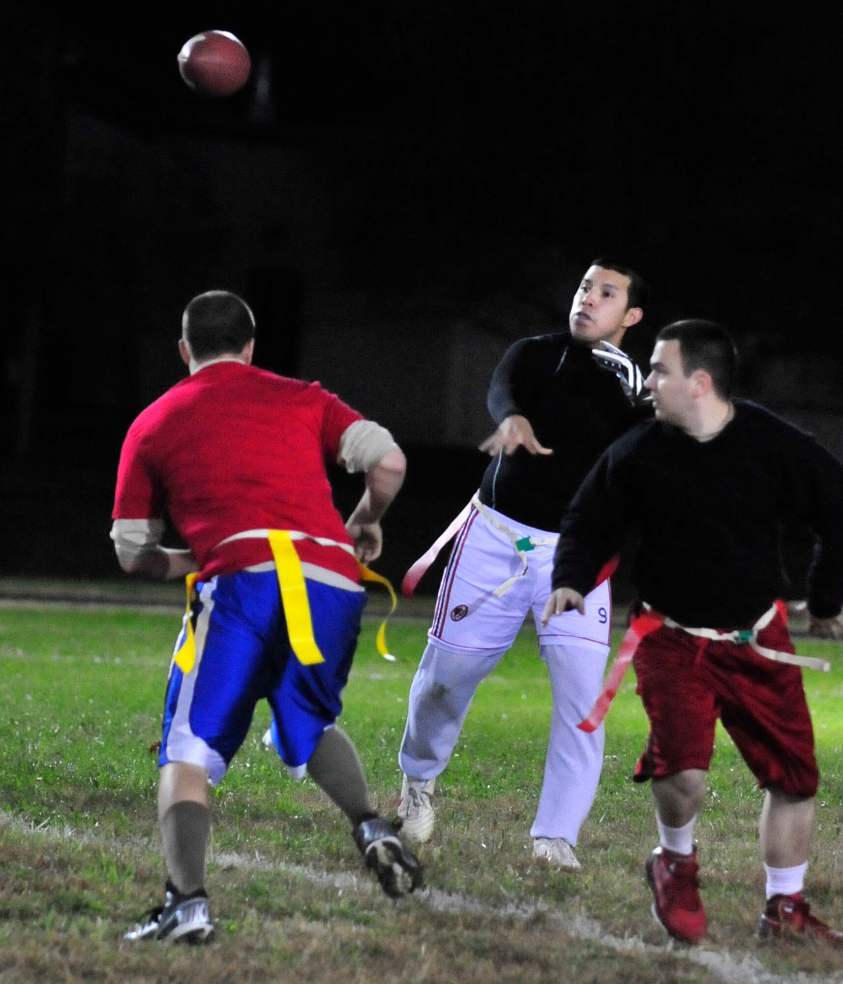 Jose Marroquin, 436th Maintenance Group/Maintenance Operations Flight quarterback, throws a pass as the 436th Civil Engineer Squadron defends during a flag football game Nov. 6, 2013, at Dover Air Force Base, Del. Marroquin ran for a touchdown in his team’s 25-6 to the 436th CES. (U.S. Air Force photo/Tech. Sgt. Chuck Walker)