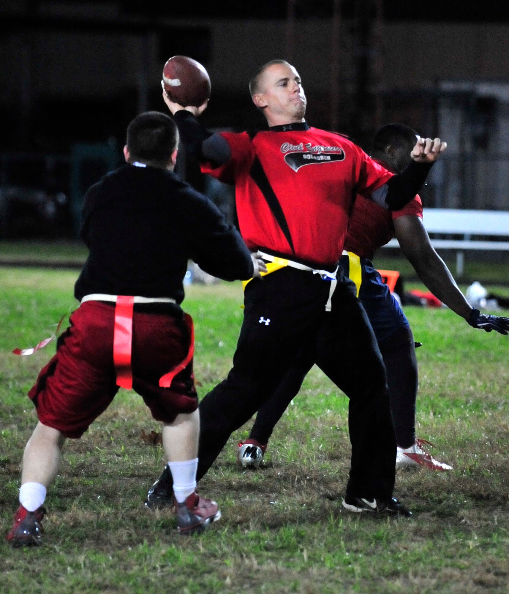 Steven Peaper, 436th Civil Engineer Squadron quarterback, throws a pass as the 436th Maintenance Group/Maintenance Operations Flight tries to defend Nov. 6, 2013, at Dover Air Force Base, Del. Peaper threw three touchdown passes and ran for another score to lead the 436th CES to a 25-6 victory. (U.S. Air Force photo/Tech. Sgt. Chuck Walker)