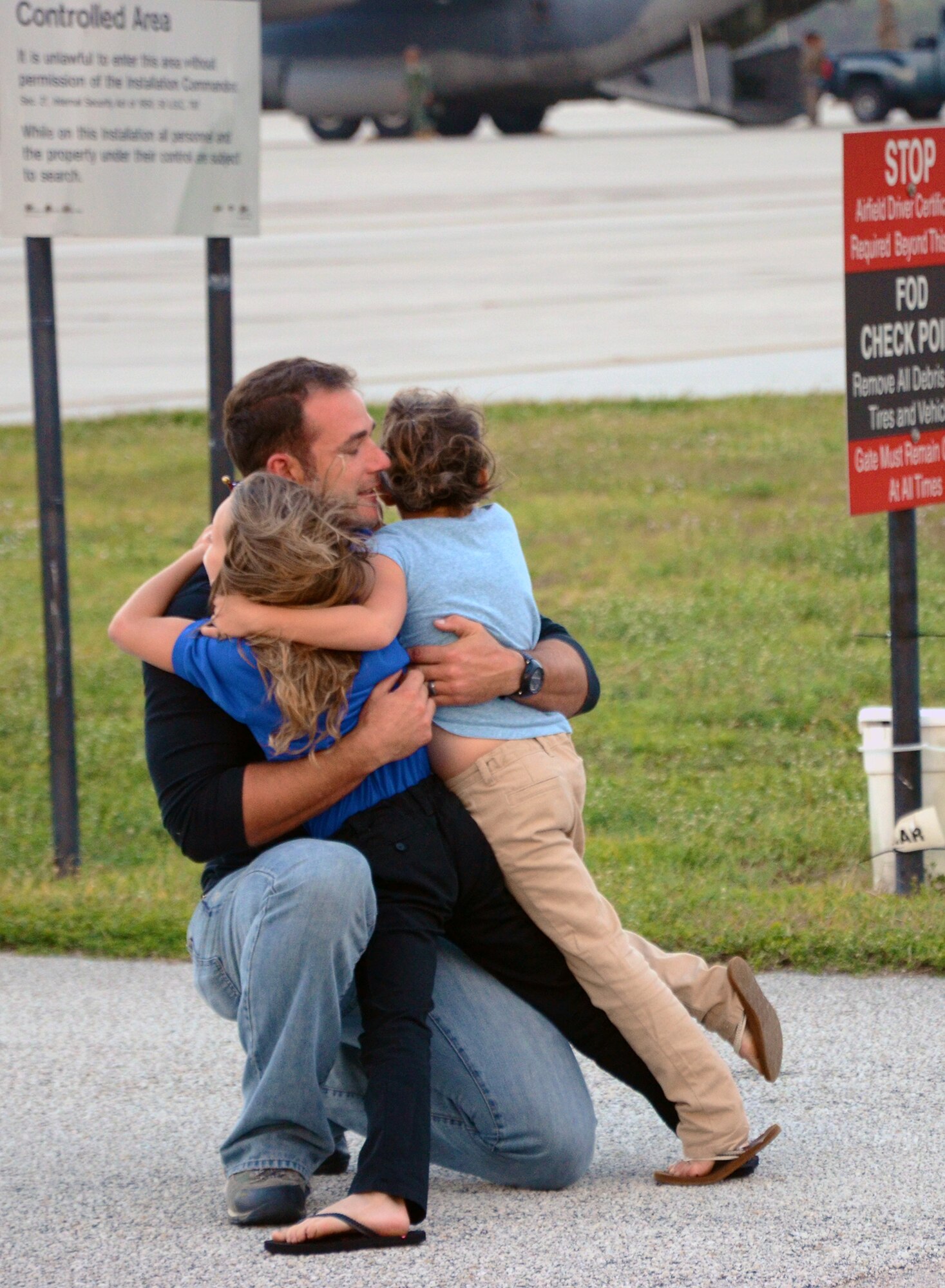 A reserve pararescueman from the 920th Rescue Wing is welcomed home by his children after returning from a deployment to the Horn of Africa. He was one of approximately 20 wing PJs and various support staff who deployed there in September to serve as part of Combined Joint Task Force - Horn of Africa. They were there to provide humanitarian aid and personnel recovery if needed. (U.S. Air Force photo/Master Sgt. Paul Flipse)