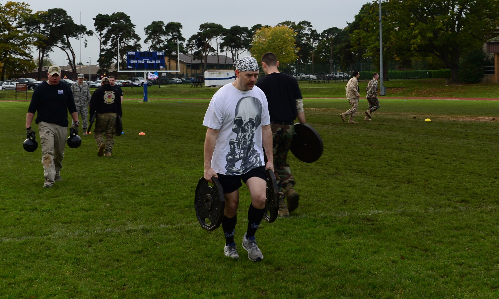 Tech. Sgt. William Weisenburg, 48th Medical Surgical Squadron diagnostic imaging craftsman, and his teammates, transfer a total of 500 pounds during the joint base Combined Federal Campaign-Overseas Combat Challenge on Royal Air Force Lakenheath, England, Nov. 8, 2013. Twenty teams from RAFs Lakenheath and Mildenhall competed in the CFC Combat Challenge to help raise money for family support and youth service programs. (U.S. Air Force photo by Airman 1st Class Dawn M. Weber/Released)