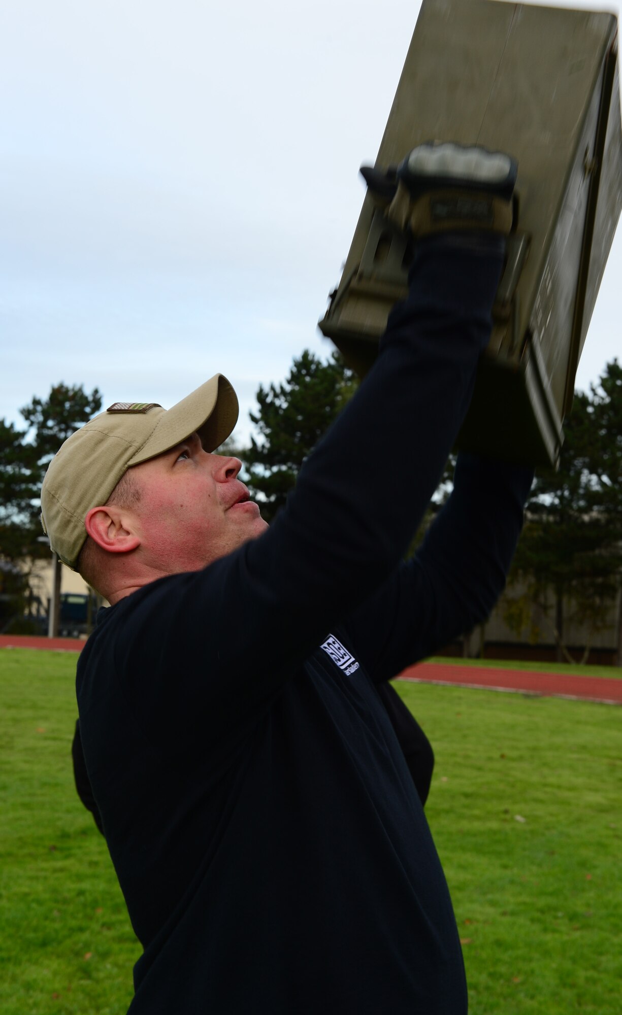 Tech. Sgt. James Clark, 48th Medical Surgical Squadron medical technician, lifts a 30-pound ammo can during the joint base Combined Federal Campaign-Overseas Combat Challenge on Royal Air Force Lakenheath, England, Nov. 8, 2013. Twenty teams from RAFs Lakenheath and Mildenhall competed in the CFC Combat Challenge to help raise money for family support and youth service programs. (U.S. Air Force photo by Airman 1st Class Dawn M. Weber/Released)