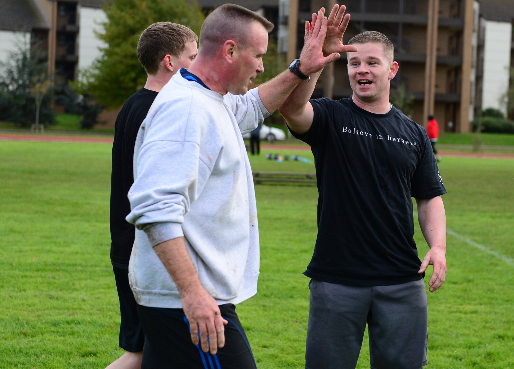 Maj. Jon Mancuso, 748th Aircraft Maintenance Squadron commander, and Tech. Sgt. Stephen Sluder, 748th AMXS section chief, celebrate after their team completes the joint base Combined Federal Campaign-Overseas Combat Challenge on Royal Air Force Lakenheath, England, Nov. 8, 2013. Twenty teams from RAFs Lakenheath and Mildenhall competed in the CFC Combat Challenge to help raise money for family support and youth service programs. (U.S. Air Force photo by Airman 1st Class Dawn M. Weber/Released)