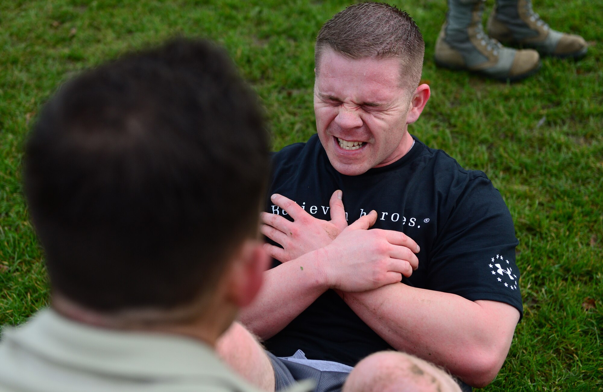 Tech. Sgt. Stephen Sluder, 748th Aircraft Maintenance Squadron section chief, does sit-ups during the joint base Combined Federal Campaign-Overseas Combat Challenge on Royal Air Force Lakenheath, England, Nov. 8, 2013. Twenty teams from RAFs Lakenheath and Mildenhall competed in the CFC Combat Challenge to help raise money for family support and youth service programs. (U.S. Air Force photo by Airman 1st Class Dawn M. Weber/Released)