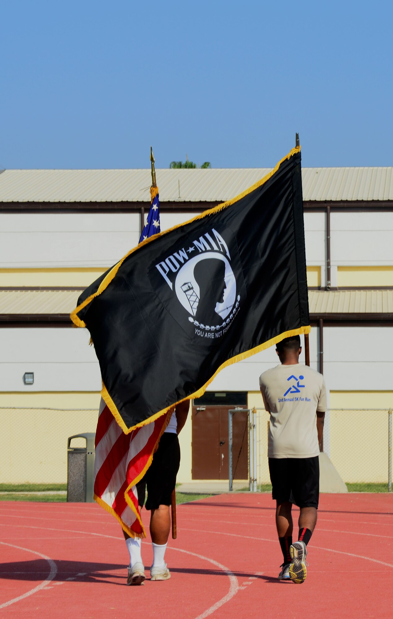 Airmen from the 39th Air Base Wing carry the American and POW/MIA flag during a 24-hour walk and run Nov. 11, 2013, at Incirlik Air Base, Turkey. The walk and run was held in remembrance of service members who were prisoners of war or missing in action. (U.S. Air Force photo by Staff Sgt. Eric Summers Jr.)
