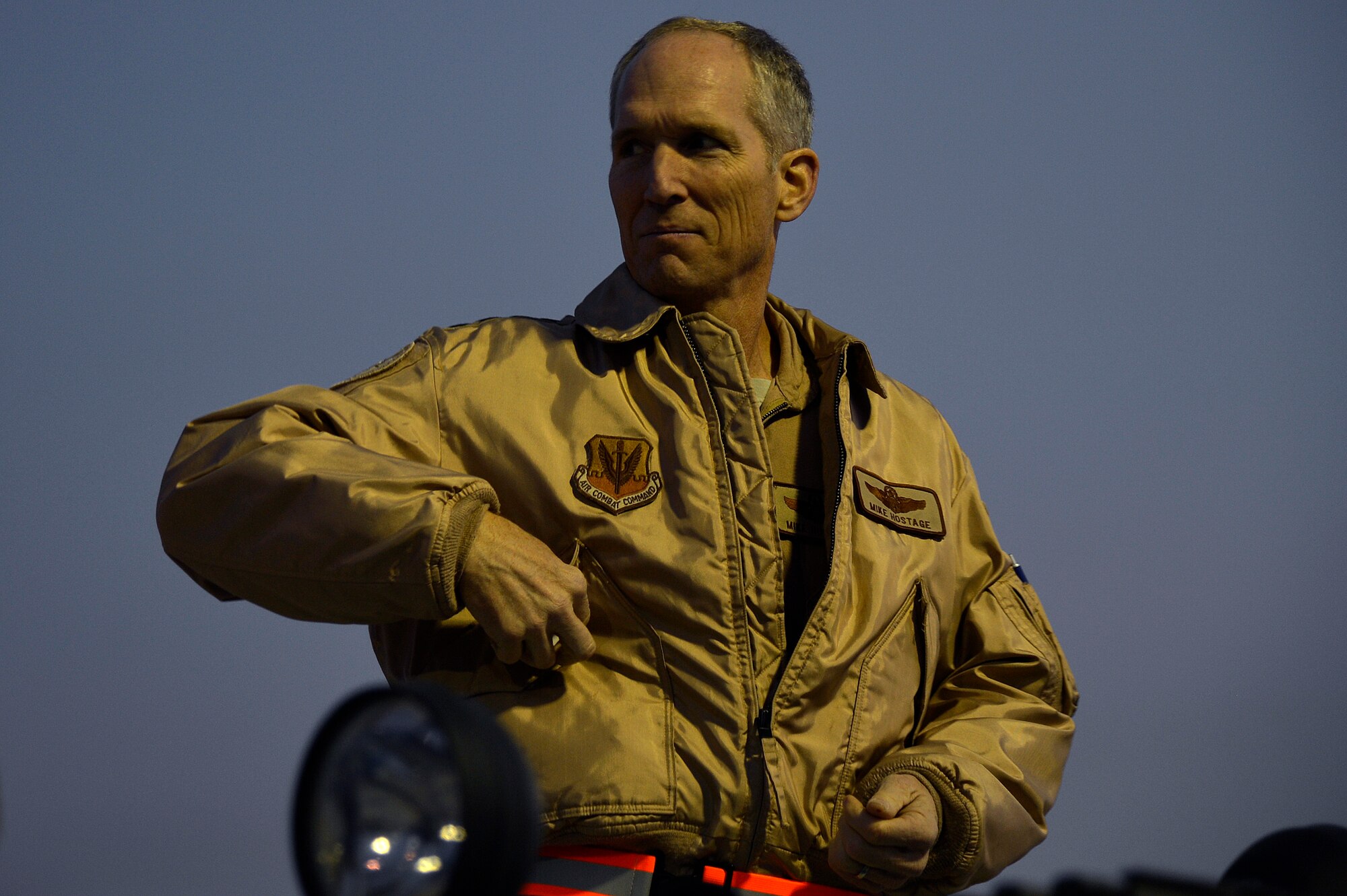 U.S. Air Force Gen. Mike Hostage, commander Air Combat Command, looks across the flight line during a tour at Bagram Airfield, Afghanistan, Nov. 9, 2013. During the first of the two days he spent at BAF, Hostage toured six different areas and gained a better understanding of expectations and requirements and also addressed concerns of deployed Airmen. (U.S. Air Force photo by Senior Airman Kayla Newman/Released)