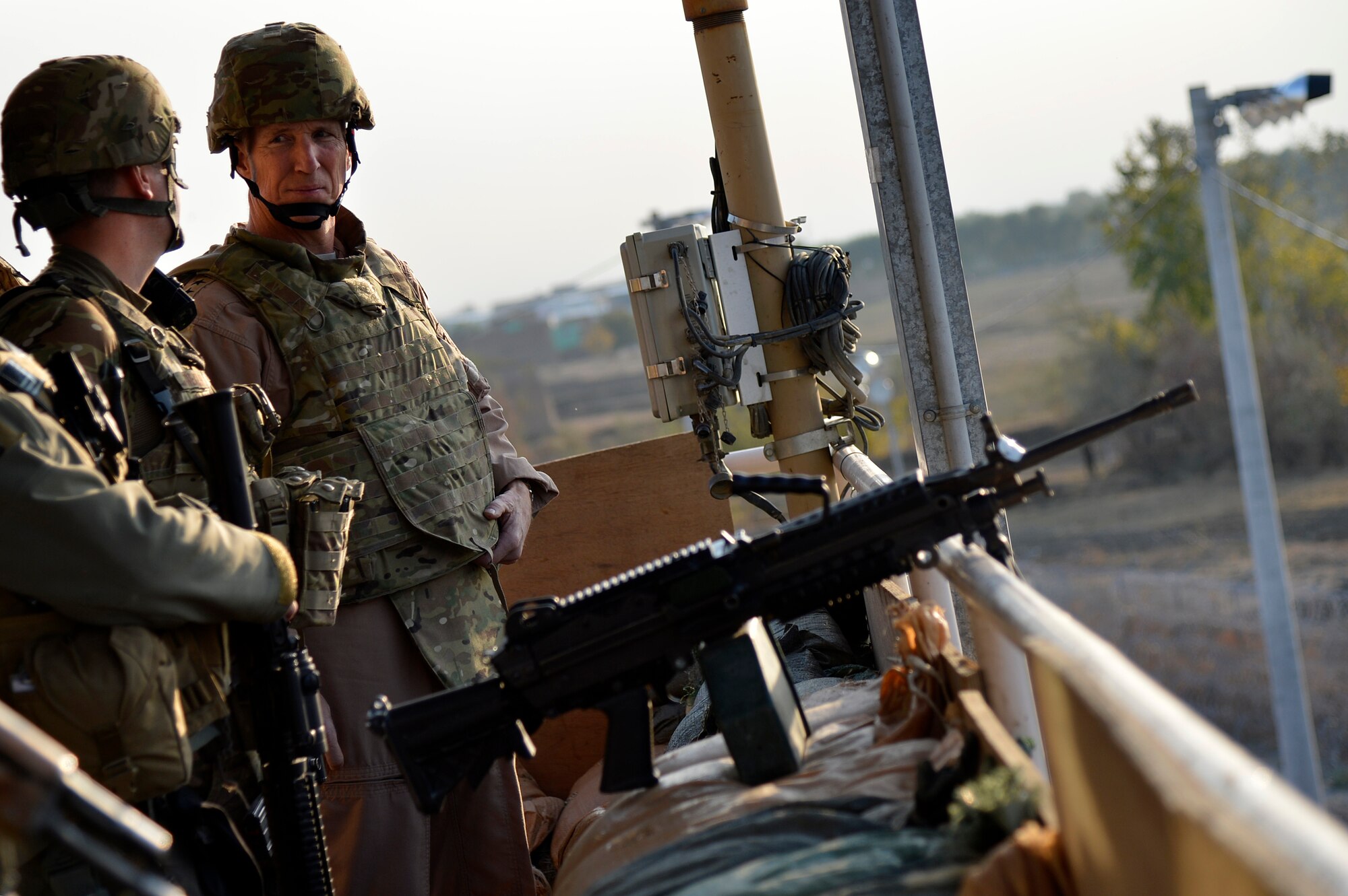U.S. Air Force Gen. Mike Hostage, commander of Air Combat Command, receives a tower brief from Senior Airman Bradly Treakle, 455th Expeditionary Base Defense Squadron, during a base tour at Bagram Airfield, Afghanistan, Nov. 9, 2013. Hostage arrived at BAF for a tour that included stops at entry control points, the 455th Expeditionary Aerial Port Squadron, and dinner with Airmen. (U.S. Air Force photo by Senior Airman Kayla Newman/Released)