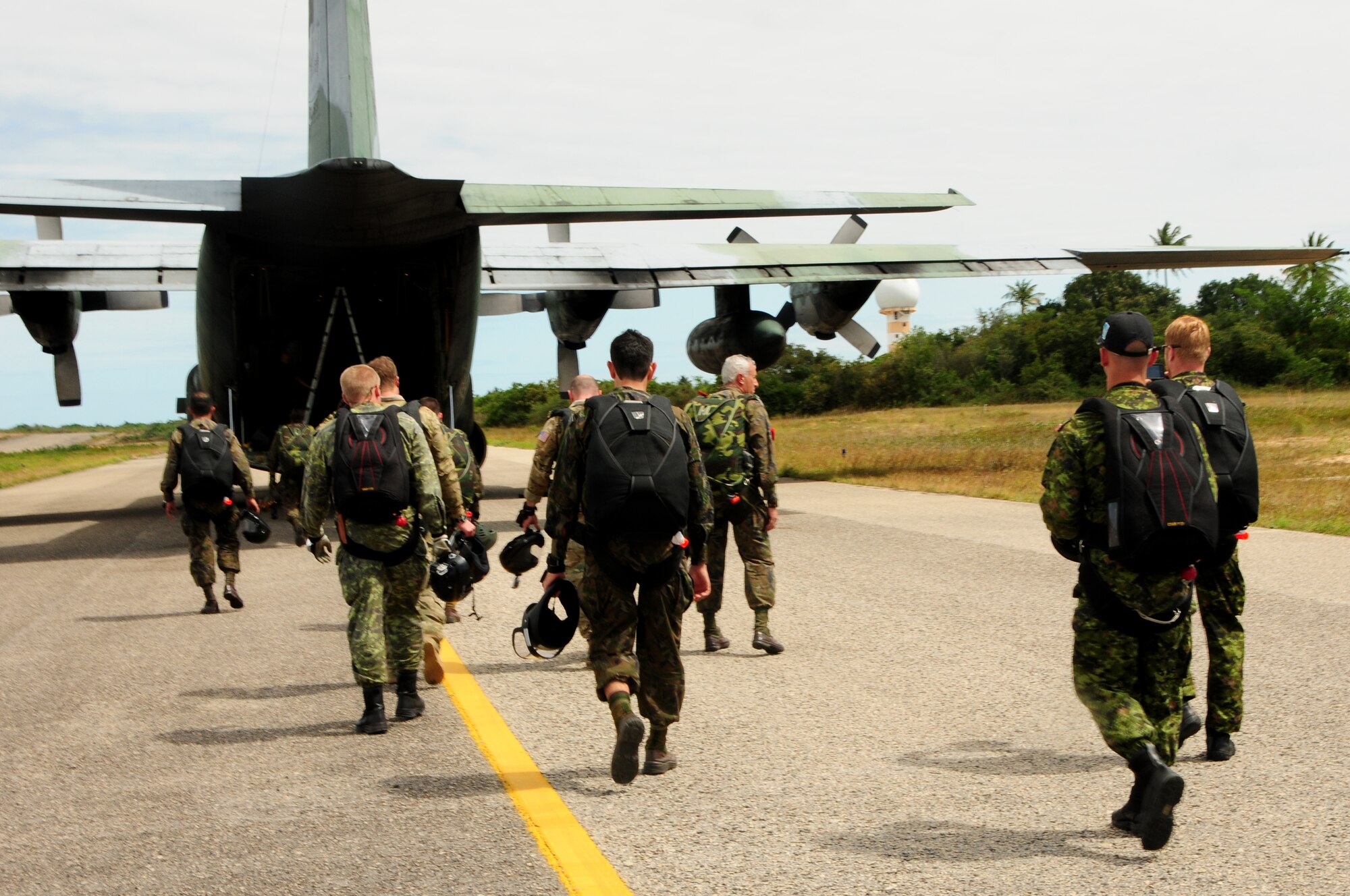 Brazilian, Canadian and U.S. pararescuemen prepare to board a Brazilian C-130E Hercules during CRUZEX at Natal Air Base, Natal, Brazil, Nov. 7, 2013. Exercises such as CRUZEX are designed and led by a host nation, partnering nations receive training opportunities that are beneficial to the entire region. (U.S. Air Force photo by Senior Airman Camilla Elizeu/Released)