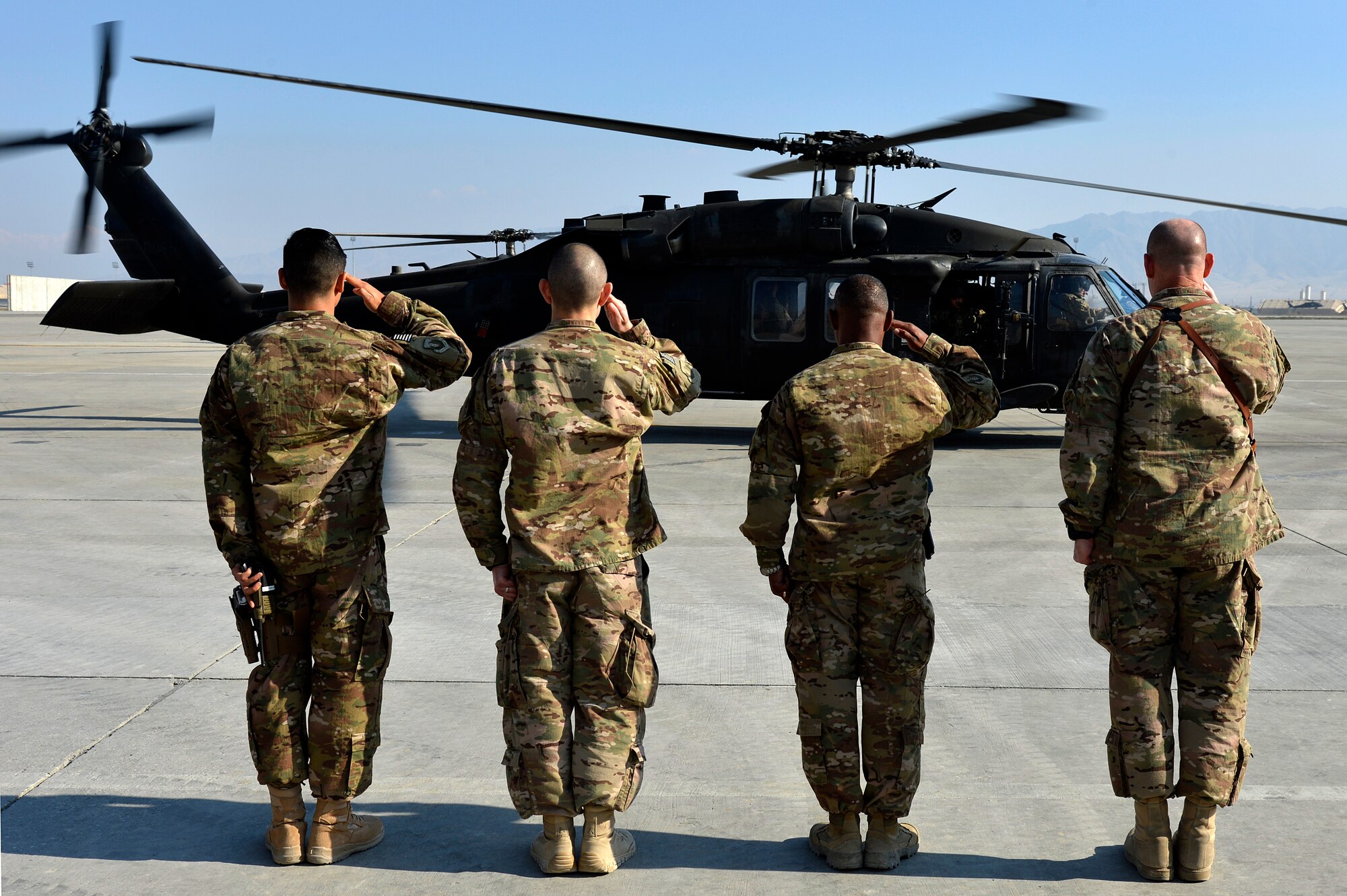Leadership from the 455th Air Expeditionary Wing salute as U.S. Air Force Gen. Mike Hostage, commander of Air Combat Command, arrives at Bagram Airfield, Afghanistan, Nov. 9, 2013. Hostage arrived at BAF for a tour that included stops at entry control points, the 455th Expeditionary Aerial Port Squadron, and dinner with Airmen. (U.S. Air Force photo by Senior Airman Kayla Newman/Released)