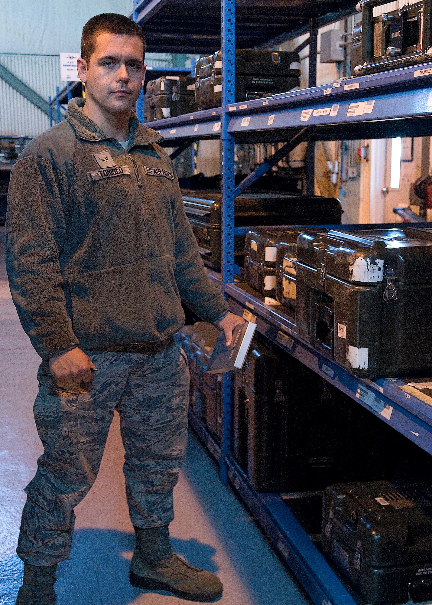 Airman 1st Class Austin Toniolo, 736th Aircraft Maintenance Squadron Composite Tool Kit support technician, poses in his work center Oct. 24, 2013, at Dover Air Force Base, Del. Toniolo is in charge of all the tools and equipment that are used on the C-17 Globemaster III’s systems. (U.S. Air Force photo/Airman 1st Class Ashlin Federick)