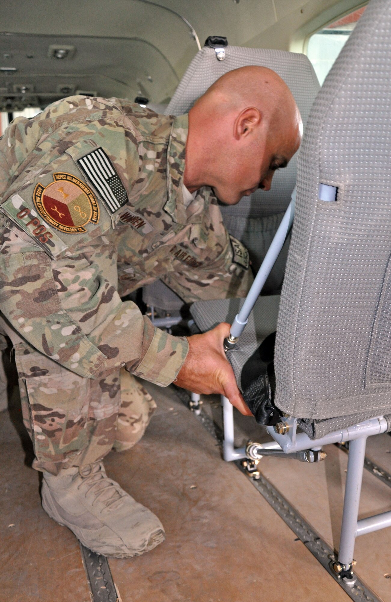 U.S. Air Force Master Sgt. Bill Warren, 442nd Air Expeditionary Advisory Squadron Cessna 208 expeditor advisor, demonstrates how to easily remove and reconfigure seats on a C-208 November 10, 2013 at Kandahar Airfield, Afghanistan. Advisors with the 738th Air Expeditionary Advisory Group at KAF, part of NATO Air Training Command-Afghanistan, have increased the passenger seating on the Afghan Air Force C-208 by 25 percent by discovering a new way to configure the seating on the aircraft. Due to this new configuration, casualty evacuation litter patients can also be increased from two to three. (U.S. Air Force photo/Capt. Anastasia Wasem)