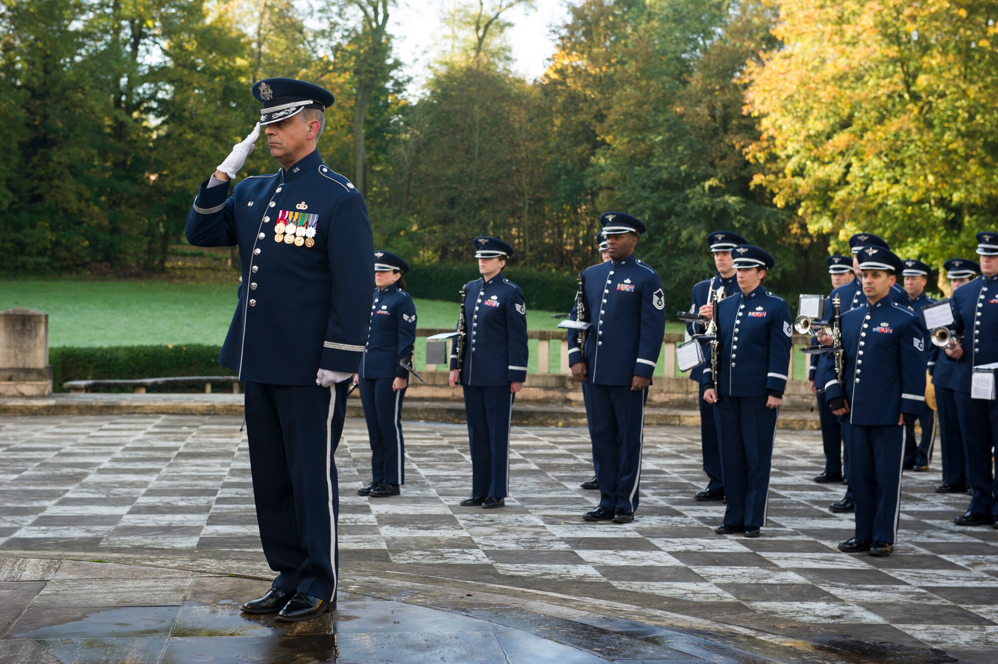 MARNES-LA-COQUETTE, France -- Lt. Col. R. Michael Mench, U.S. Air Forces in Europe Band commander, salutes in front of his band during a Veteran’s Day Ceremony at the Lafayette Escadrille memorial in Marnes-la-Coquette, France, Nov. 11, 2013. Lafayette Escadrille was a French Air Service squadron during World War I comprised largely of volunteer American fighter pilots. (U.S. Air Force photo/Tech. Sgt. Benjamin Wilson)