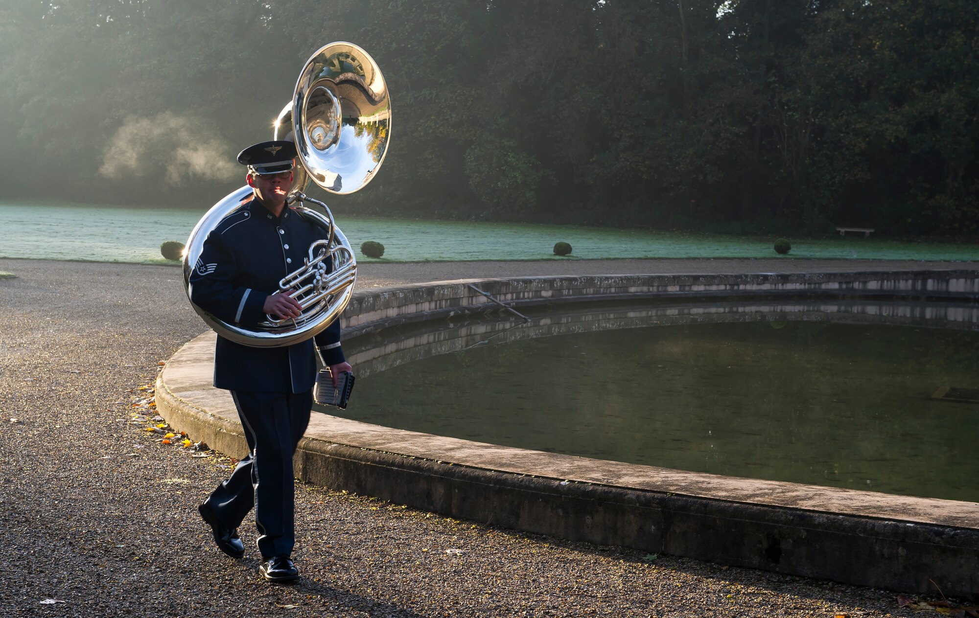 MARNES-LA-COQUETTE, France -- The tuba player for the U.S. Air Forces in Europe Band arrives at the Lafayette Escadrille memorial in Marnes-la-Coquette, France Nov. 11, 2013. The band played during a Veteran’s Day ceremony honoring the volunteer fighter pilots of Lafayette Escadrille. (U.S. Air Force photo/Tech. Sgt. Benjamin Wilson)