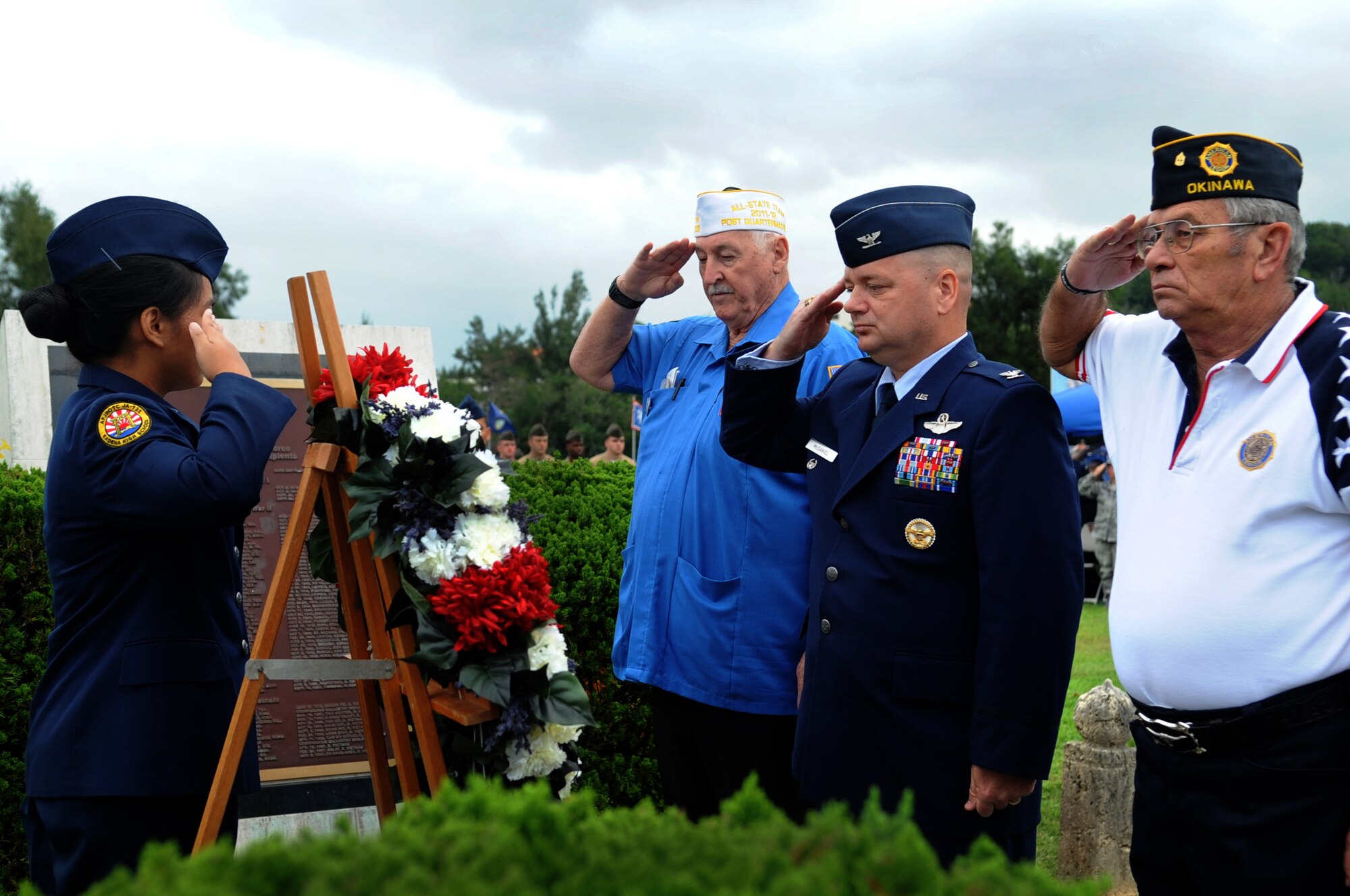 Charles Cathey (right), Okinawa American Legion post 28 commander, U.S. Air Force Col. Brian McDaniel, 18th Wing vice commander, and Dennis Provencher, Okinawa Veterans of Foreign Wars post 9723 commander, salute a POW/MIA wreath as it is placed in front of the command building flagpoles during a Veterans Day ceremony at Kadena Air Base, Japan, Nov. 11, 2013. President Woodrow Wilson first commemorated Nov. 11 as Armistice Day in 1919 to honor the veterans of World War I. The day was later changed to Veterans Day in 1954 by President Dwight Eisenhower to honor all veterans from all U.S. conflicts. (U.S. Air Force photo by Staff Sgt. Amber E. N. Jacobs)