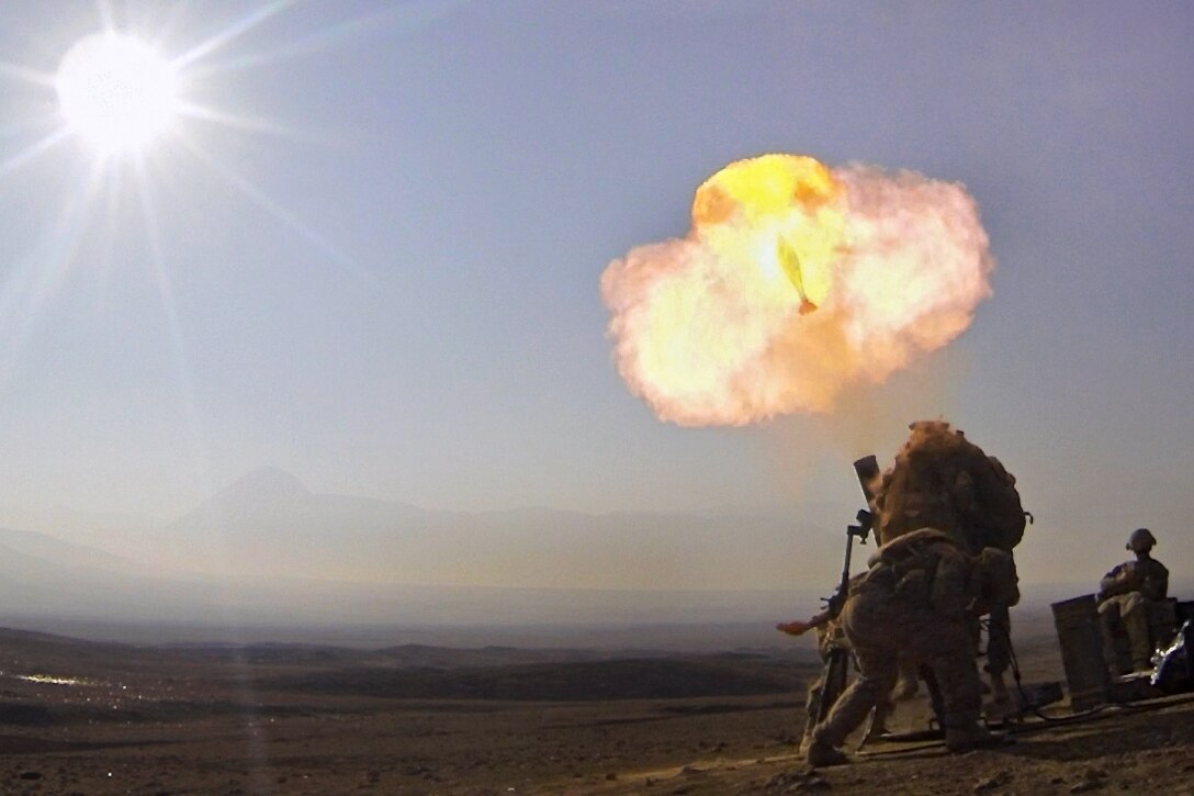 U.S. Army Pfcs. Kyle Wilkinson and Richard Setzer react to the baseplate slamming into the ground after firing the first 120mm mortar round for their mortar live-fire exercise from their observation post near Combat Outpost Khilaguy, Afghanistan, Nov. 9, 2013. Wilkinson and Setzer are mortarmen assigned to the 1st Infantry Division's 6th Squadron, 4th Cavalry Regiment, 3rd Brigade Combat Team.