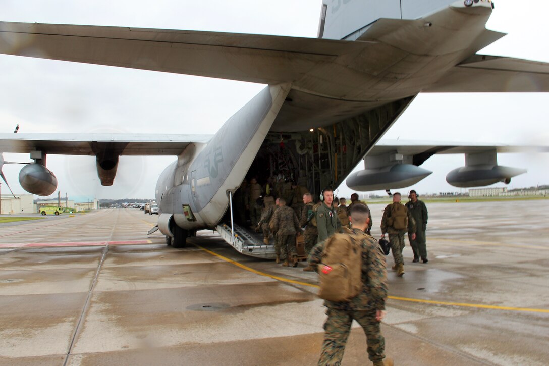 U.S. Marines and sailors board a KC-130J Hercules aircraft on Marine Corps Air Station Futenma, Okinawa, Japan, Nov. 12, 2013. The Marines and sailors, assigned to the 3rd Marine Expeditionary Brigade, 3rd Marine Expeditionary Force, are deploying to provide humanitarian assistance and disaster relief operations in the wake of Typhoon Haiyan in the Philippines.