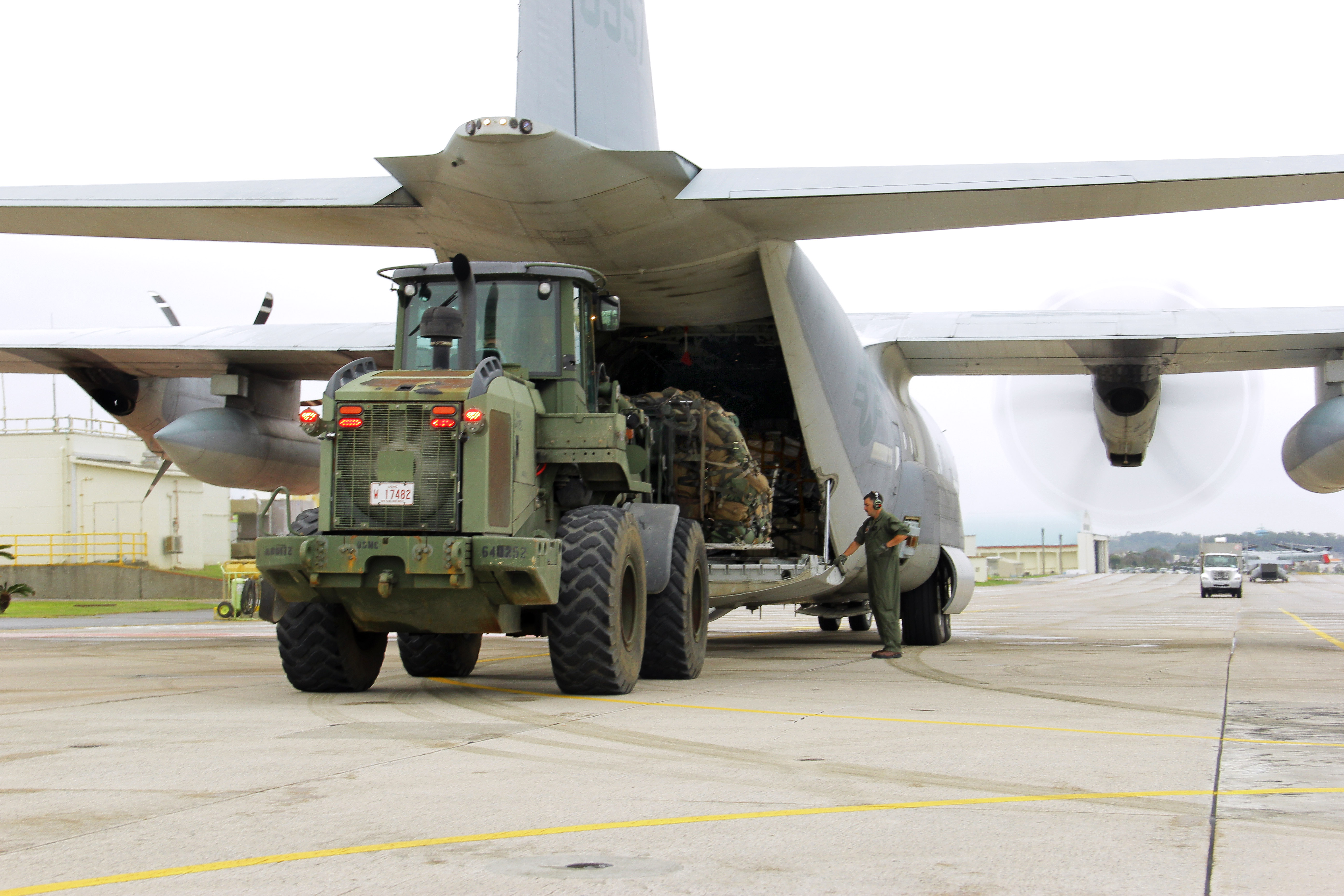 U.s. Marines Use A Large Forklift To Load A Pallet Of Gear Onto A Kc-130J