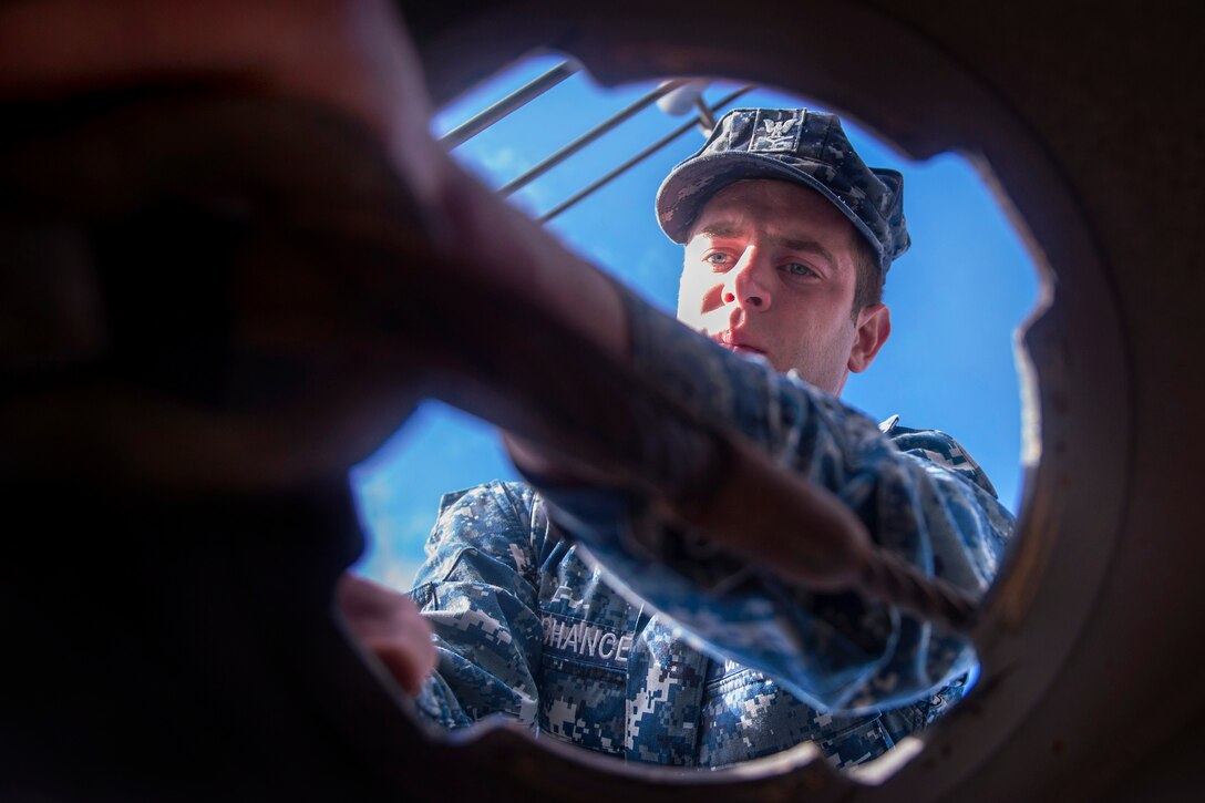 Navy Petty Officer 3rd Class Sean Lachance prepares to secure the bow aboard the USS New York in the Atlantic Ocean, Nov. 6, 2013. The New York, which is forged from steel from the World Trade Center, departed Naval Station Norfolk to conduct training and participate in Veterans Week New York City, honoring the service of the nation's veterans. Lachance is a boatswain's mate.