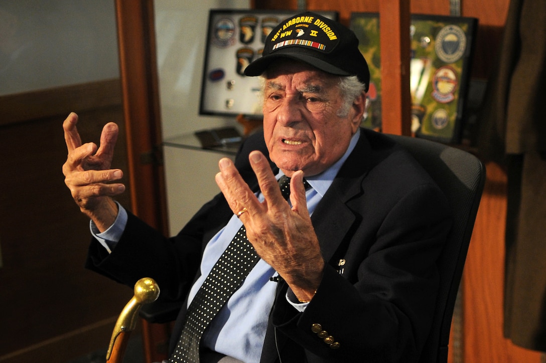 World War II veteran Vincent Speranza pauses while recounting his experiences fighting in the siege of Bastogne, Belgium, during the Battle of the Bulge while visiting with soldiers on Joint Base Elmendorf-Richardson, Alaska, Nov. 6, 2013. Speranza, a combat veteran of Company H, 501st Parachute Infantry Regiment, then part of the 101st Airborne Division, fought at Bastogne, was wounded in combat shortly after the Battle of the Bulge. The soldiers are assigned to the 25th Infantry Division's 1st Battalion Airborne, 501st Infantry Regiment, U.S. Army Alaska's 4th Infantry Brigade Combat Team Airborne.