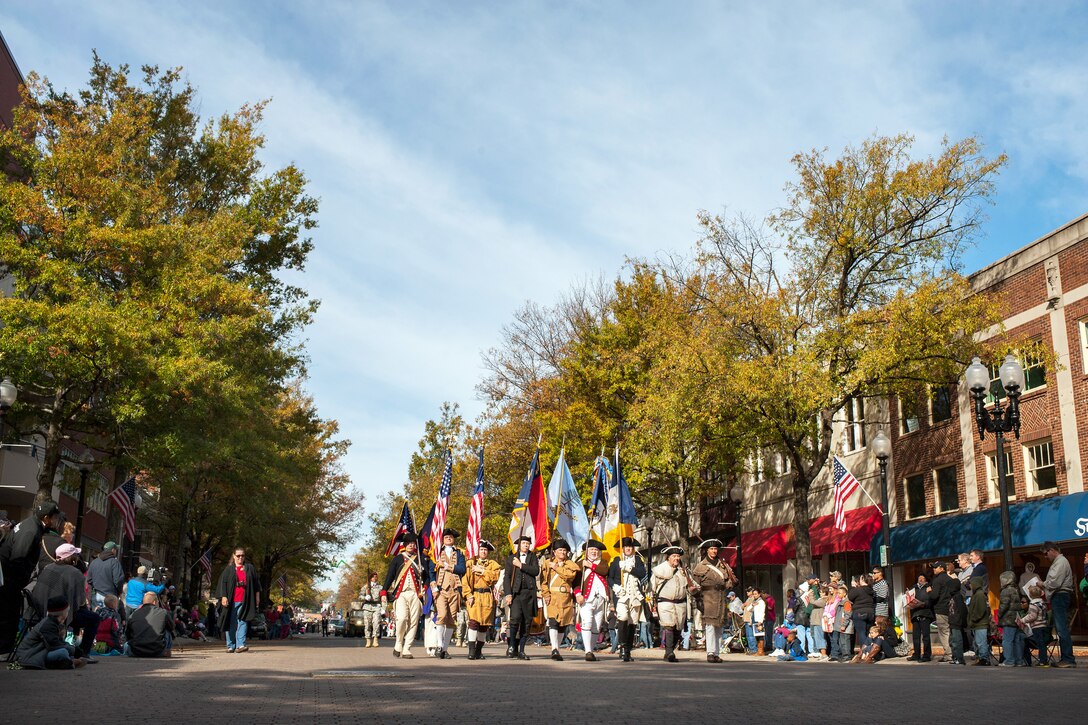 Colonial reenactors march down Hay Street in the Fayetteville Veterans