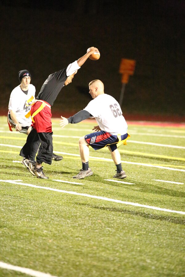 An M&RA player dodges opponents from the H&S Finance team during a game at Butler Stadium on Nov. 5, 2013. The Black Ops beat the Finance team 50-0.