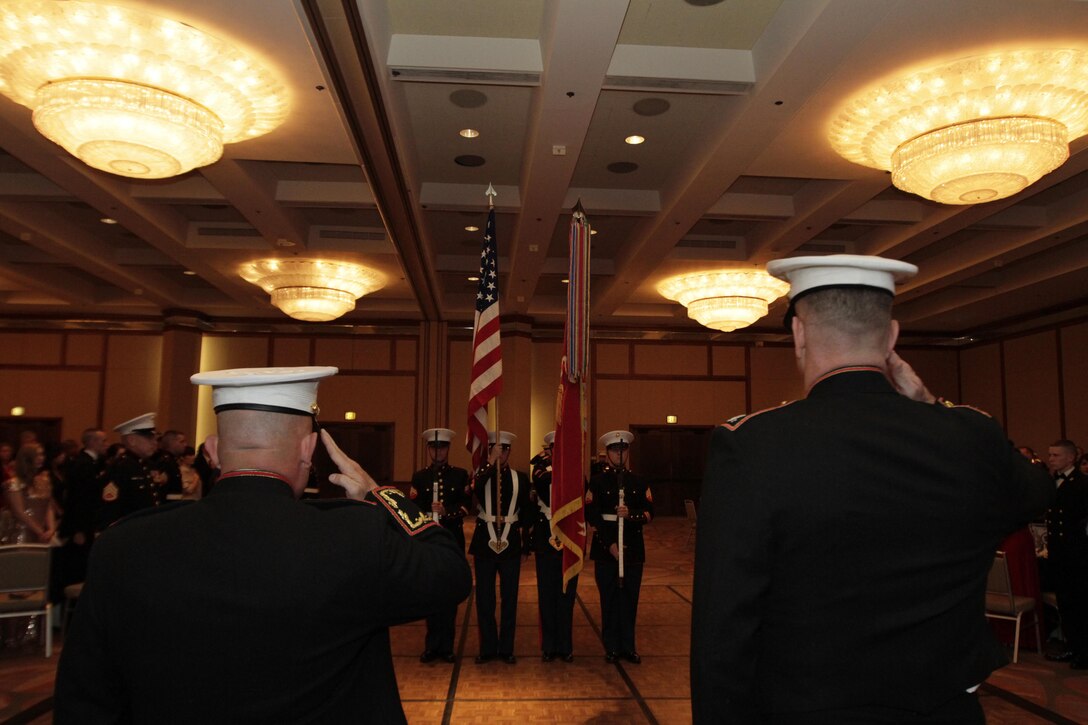 Col. Austin Renforth, commanding officer, 7th Marine Regiment and Col. James Minick commanding officer of 9th Marine Corps District (9MCD) salute the colors during the 9MCD birthday ball Nov. 8, 2013. Renforth was the guest of honor for the 9MCD ball.