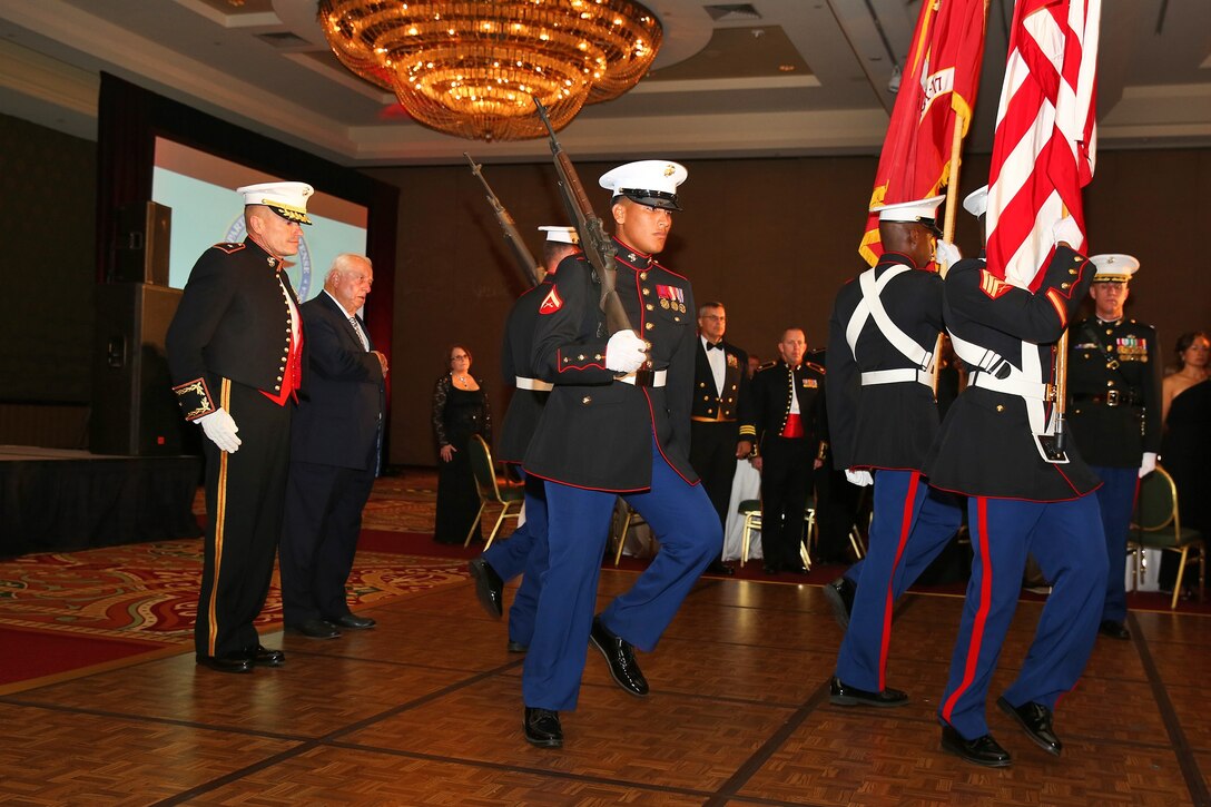 Brigadier Gen. Vincent A. Coglianese, commanding general, 1st Marine Logistics Group, and Tommy Lasorda, a member of the Baseball Hall of Fame, observe a color guard during the 1st MLG Officer’s Ball in San Diego, Nov. 8, 2013.  Lasorda, the former manager of the Los Angeles Dodgers and World War II veteran, was the guest of honor at the ceremony. 