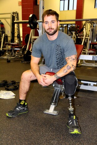John Patterson, a wounded warrior and medically retired Marine, was injured when a bomb went off as he entered a building during a combat patrol Jan. 23, 2011. The blast severed his left leg below the knee. Patterson, a native of Columbia, Md., now works as an intern at Program Executive Officer Land Systems through the Wounded Warrior Intern Program, part of the Naval Acquisition Development Program. 