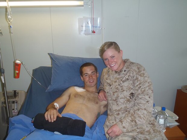 Lance Cpl. John Patterson, a native of Columbia, Md., takes a photo with his sister Lance Cpl. Karlyn Patterson while recovering from a combat injury in January 2011 at Camp Bastion in Afghanistan. Patterson’s left leg was severed below the knee when a bomb went off as he entered a building during a combat patrol Jan. 23, 2011. He now works as an intern at Program Executive Officer Land Systems through the Wounded Warrior Intern Program, part of the Naval Acquisition Development Program. 