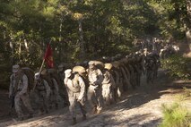 Virginia Beach, Va (Sept. 27, 2013) - Col. Paul Ryan, commanding officer, Headquarters and Service Battalion, U.S. Marine Corps Forces Commnad, carries an M240G medium machine gun as he leads his Marines on a six mile conditioning hike Sept. 27. The Marines  followed up the Friday morning hike with values based training, a barbeque and vollyball and bean bag toss.