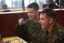 Two Marines enjoy lunch during a Marine Corps birthday celebration aboard Camp Lejeune, N.C., Nov. 7, 2013. Marines who ate lunch at the messhall were served by the senior leadership of 2nd MLG to commemorate the 238 years of the Marine Corps