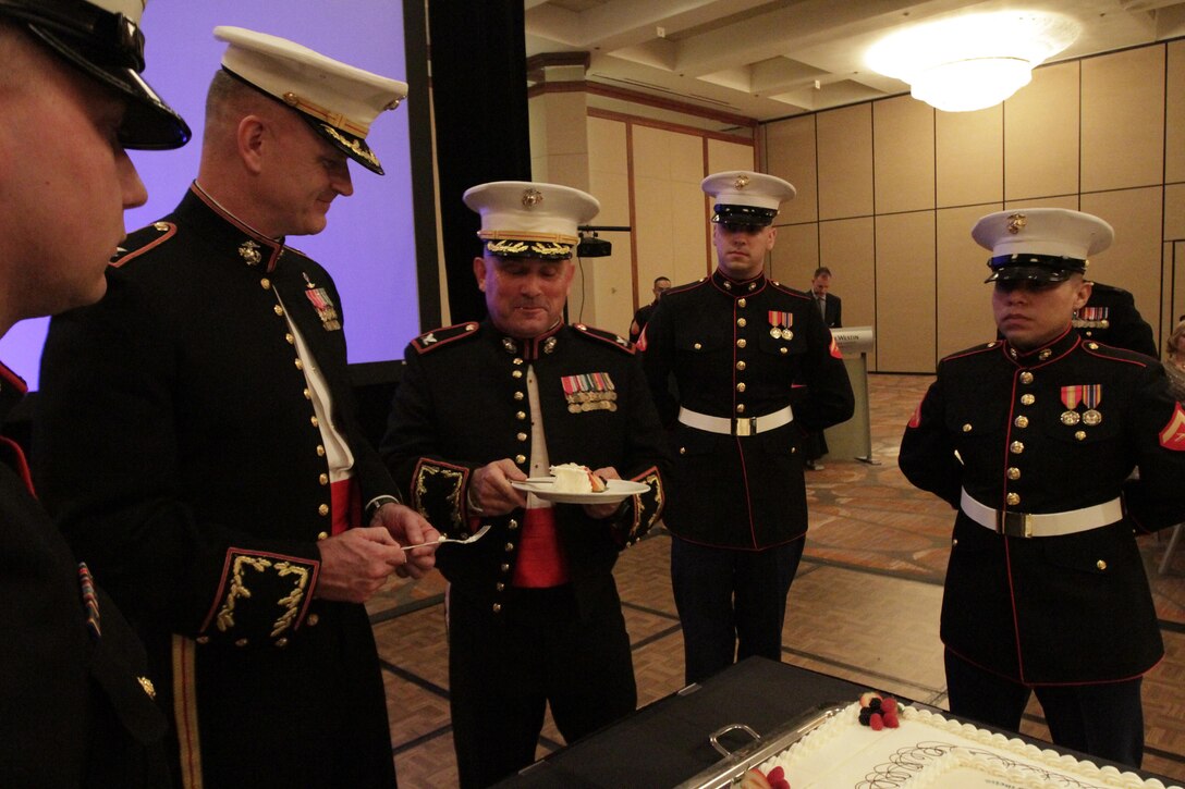 Col. Austin Renforth, commanding officer, 7th Marine Regiment and Col. James Minick commanding officer of 9th Marine Corps District (9MCD) salute the colors during the 9MCD birthday ball Nov. 8, 2013. Renforth was the guest of honor for the 9MCD ball.