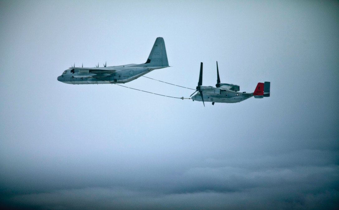 An MV-22B Osprey tiltrotor aircraft receives fuel Oct. 30 from a KC-130J Super Hercules refueling aircraft during daytime aerial refueling training. The Osprey is with VMM-265 (REIN), and the KC-130 is with Marine Aerial Refueler Transport Squadron 152, MAG-36. (U.S. Marine Corps photo by Lance Cpl. Anne K. Henry/Released)