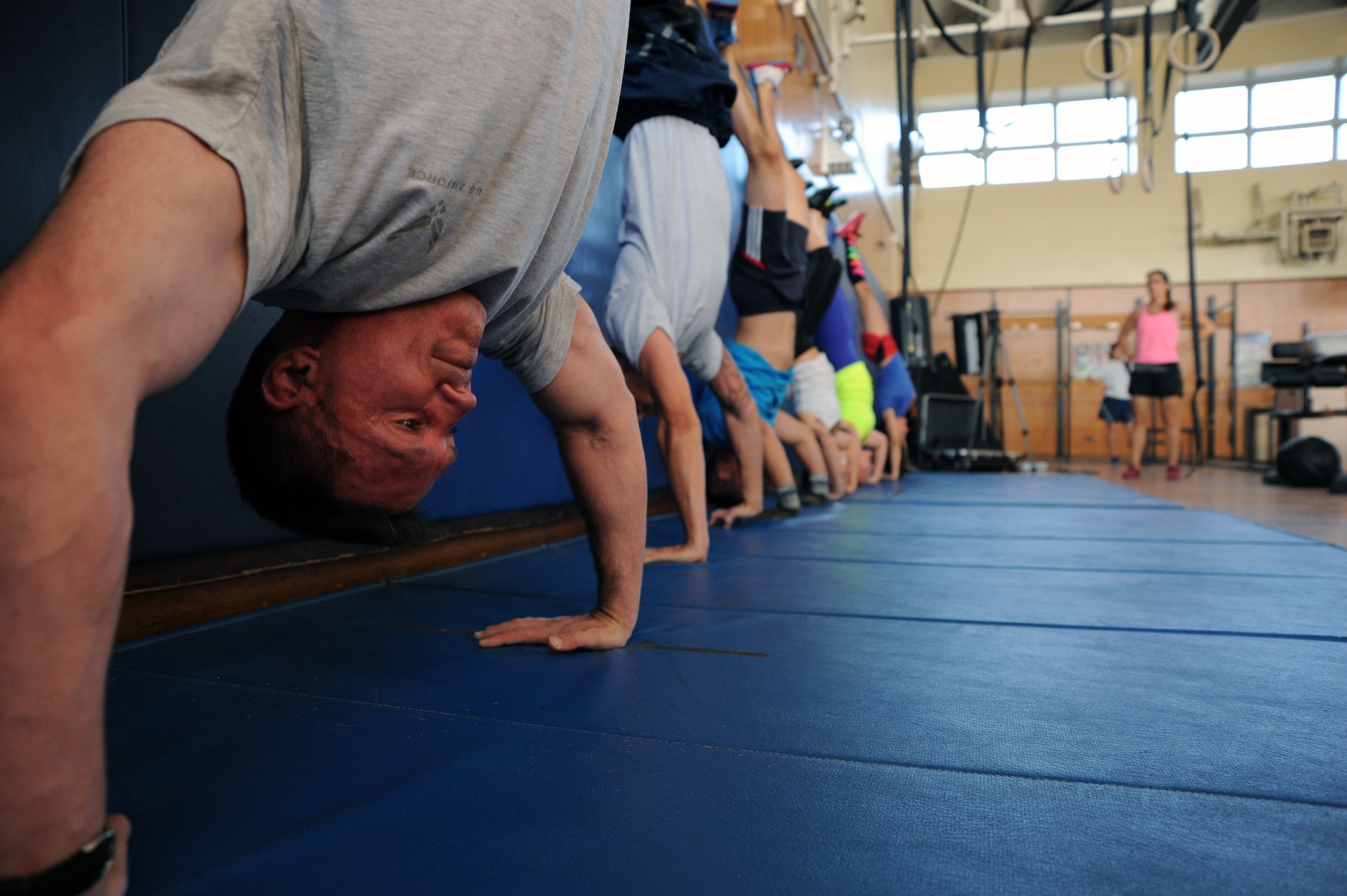 Lt. Col. Hall Sebren, 35th Maintenance Group deputy commander, performs handstand pushups at the fitness center at Misawa Air Base, Japan, Nov. 5, 2013. Sebren leads daily early morning workouts for Misawa Airmen, civilians and their dependents. (U.S. Air Force photo by Senior Airman Derek VanHorn)