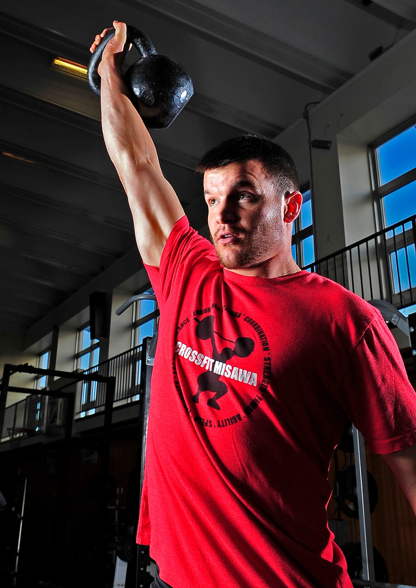 Daniel Hershey, 35th Aerospace Medicine Squadron, performs a one-arm kettle bell exercise at the fitness center at Misawa Air Base, Japan, Nov. 13, 2013. Hershey is an exercise physiologist at the base’s Health and Wellness Center where he works with Airman and their fitness. (U.S. Air Force photo by Airman 1st Class Zachary Kee) 