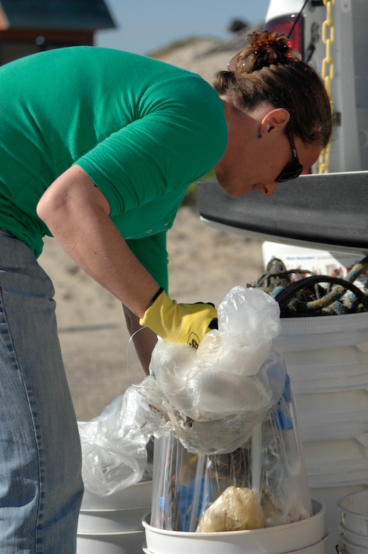 VANDENBERG AIR FORCE BASE, Calif. -- Lindsay Jacobs, VAFB contractor and volunteer, separates collected items into groups of trash and recyclables during Beach Cleanup Day here Wednesday, Nov. 13. (U.S. Air Force photo/Michael Peterson)